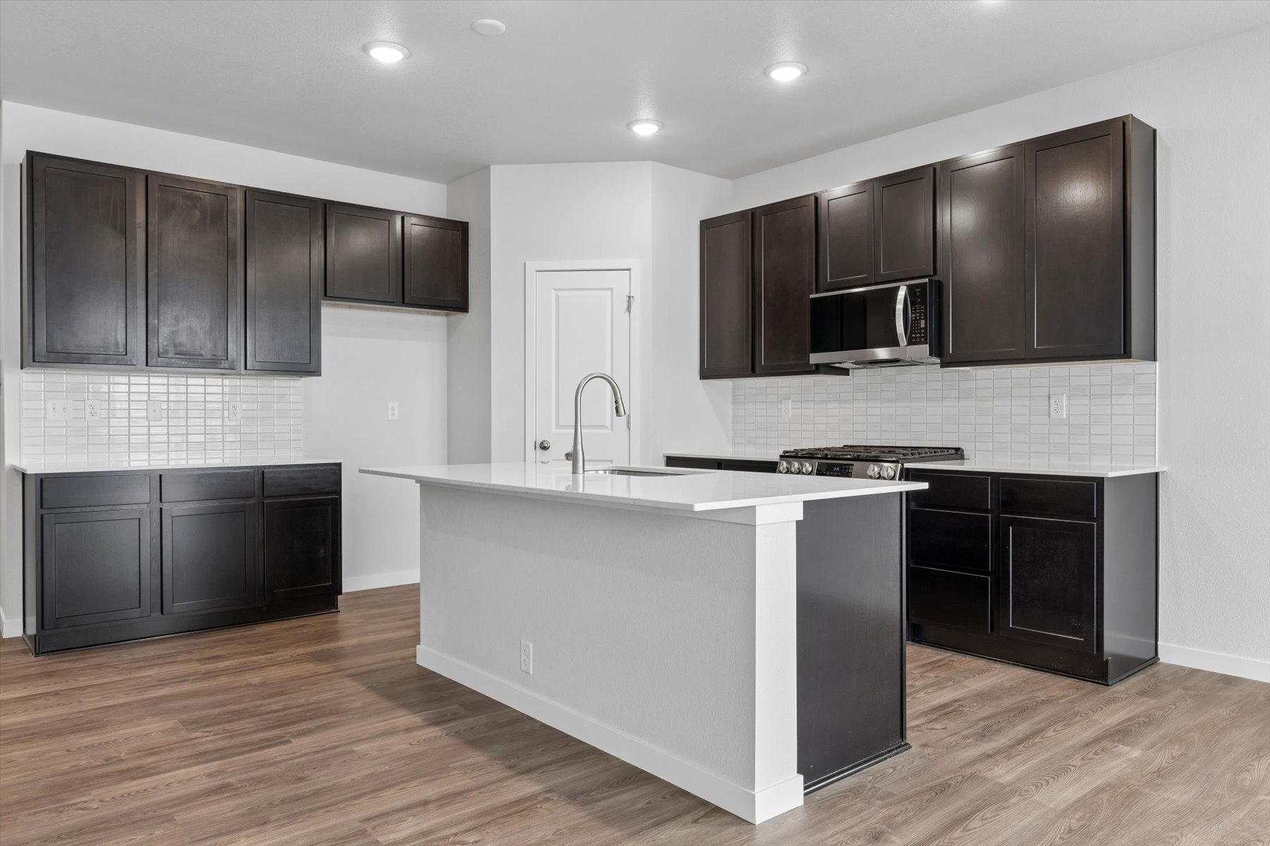 A kitchen with black cabinets.