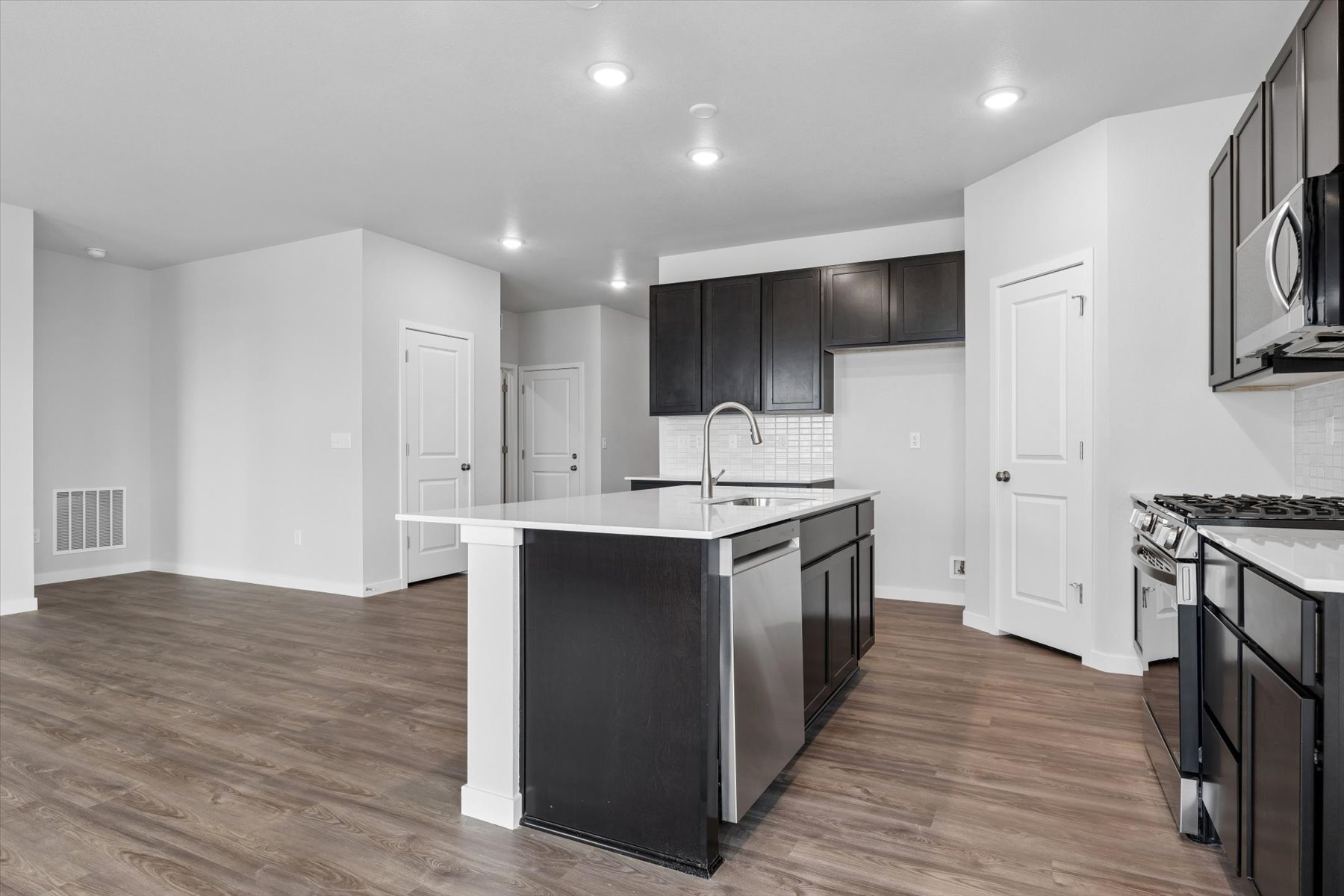 A kitchen with black cabinets.
