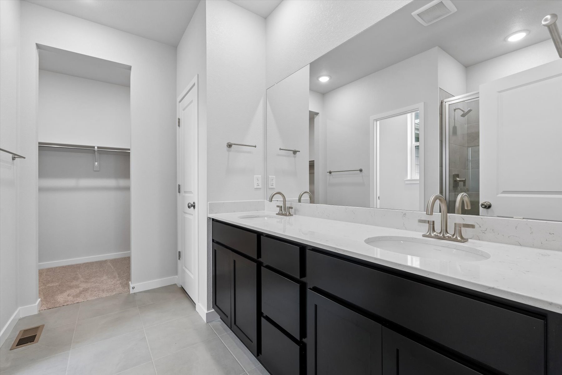 A bathroom with a large mirror.