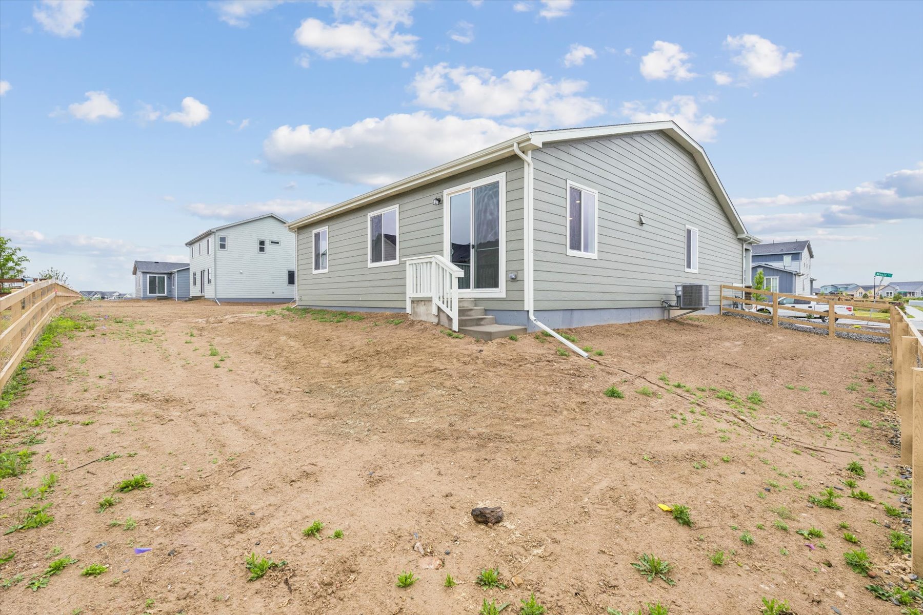 A house with a dirt yard.
