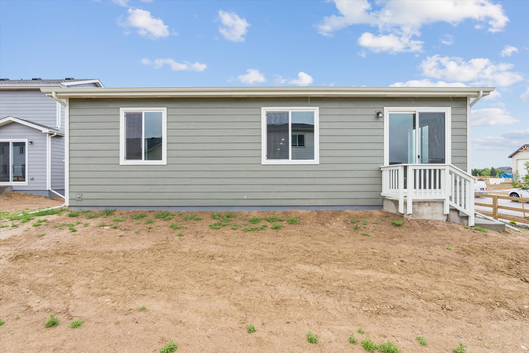 A house with a dirt yard.