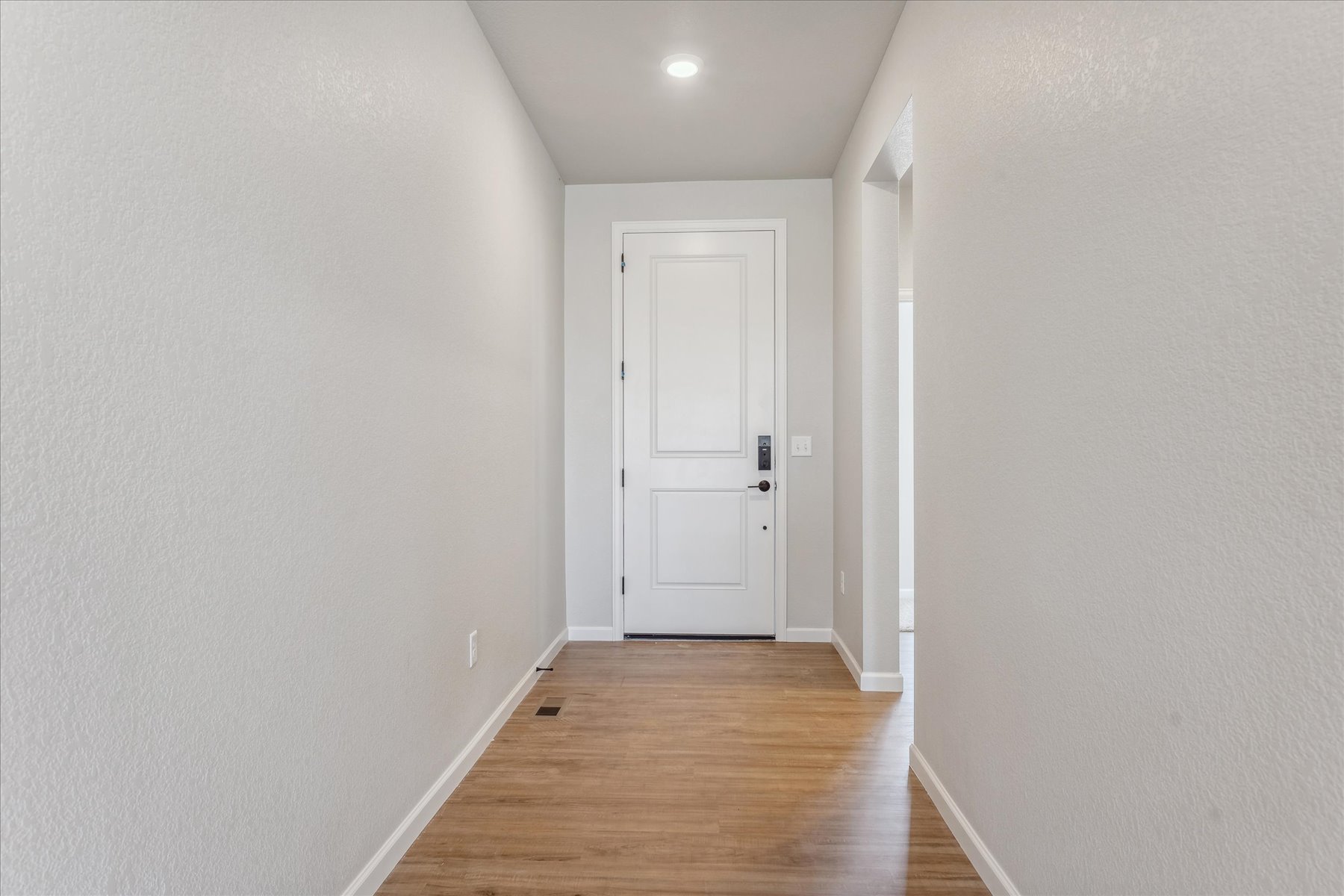 A hallway with white doors.