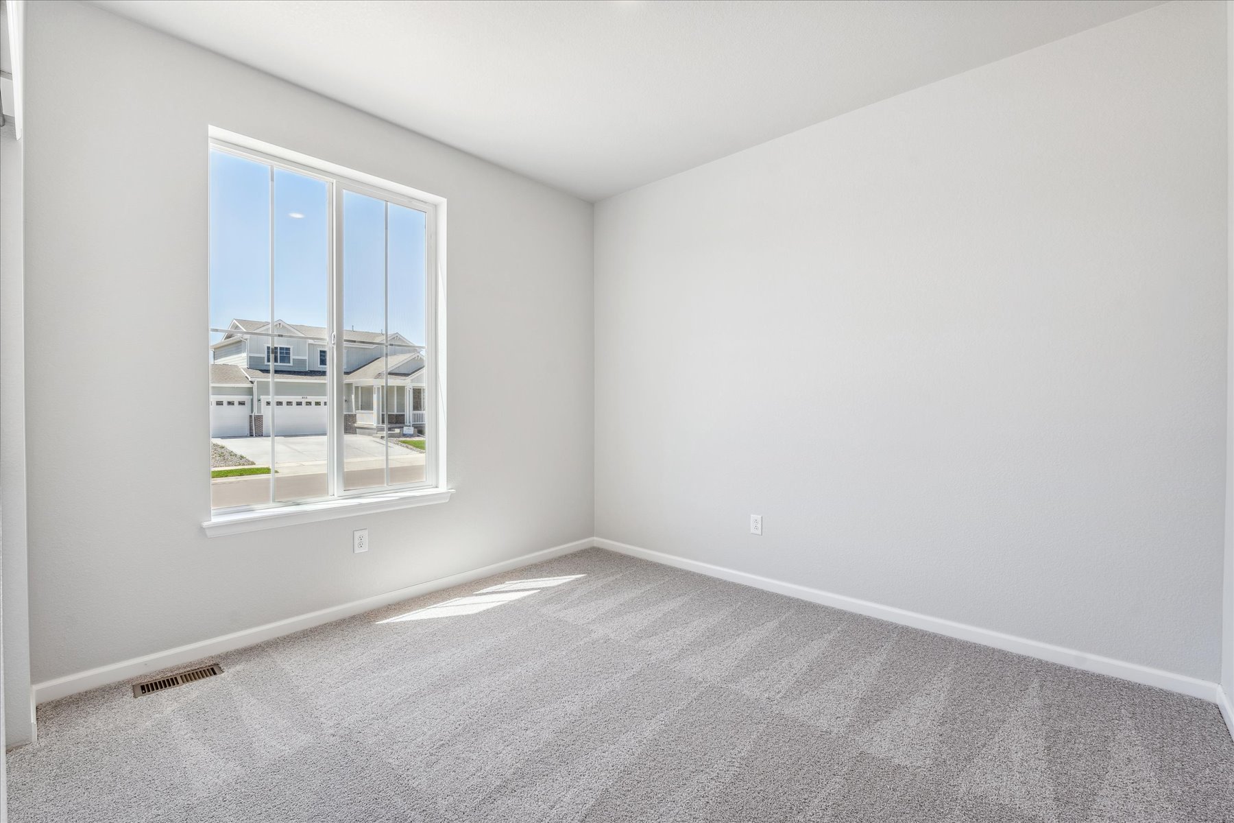 A room with a window and a door.