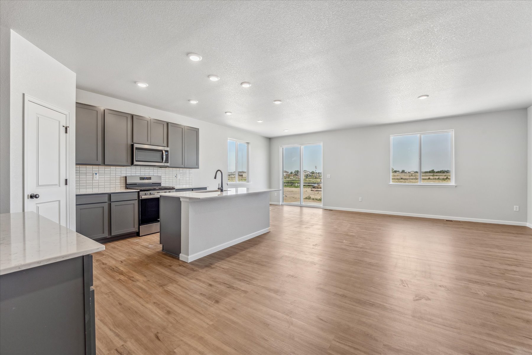 A large kitchen with black cabinets.
