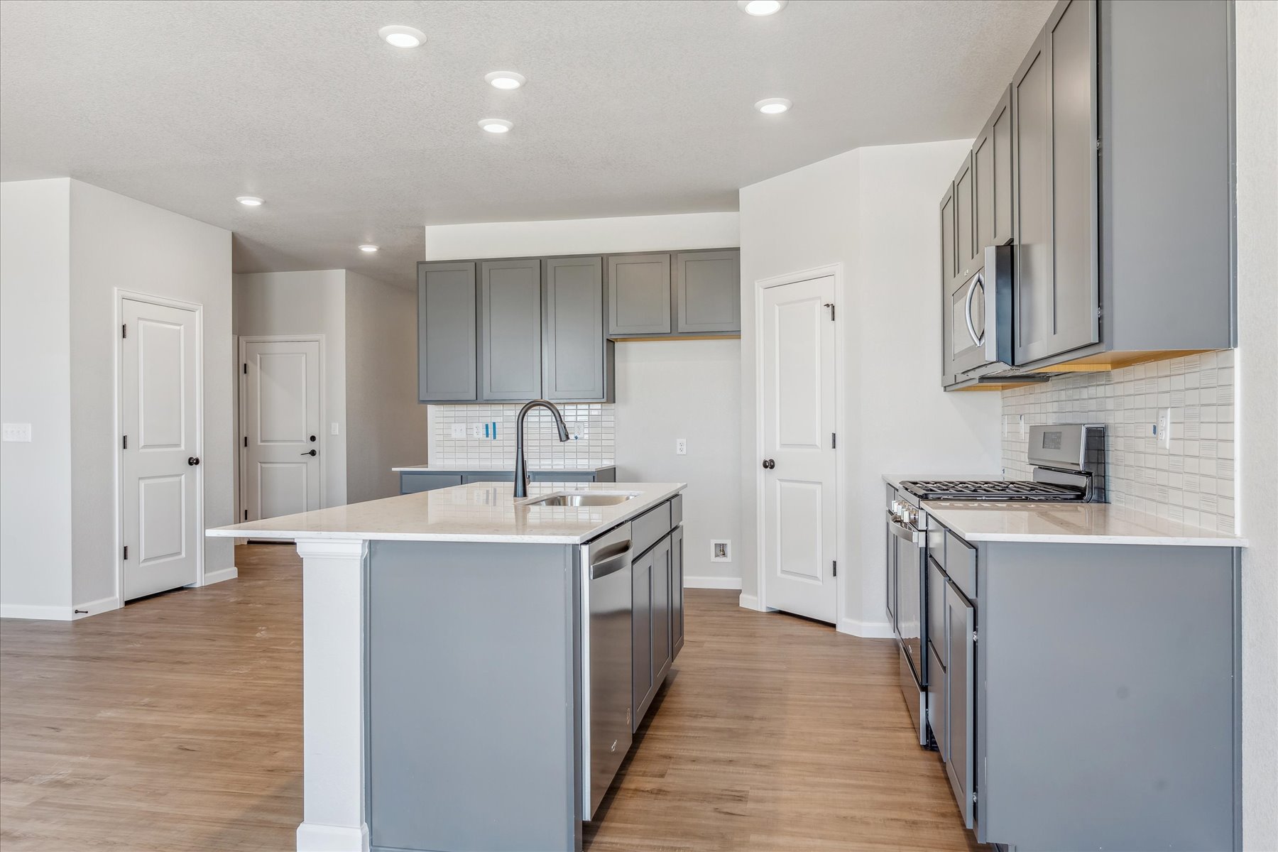 A kitchen with white cabinets.