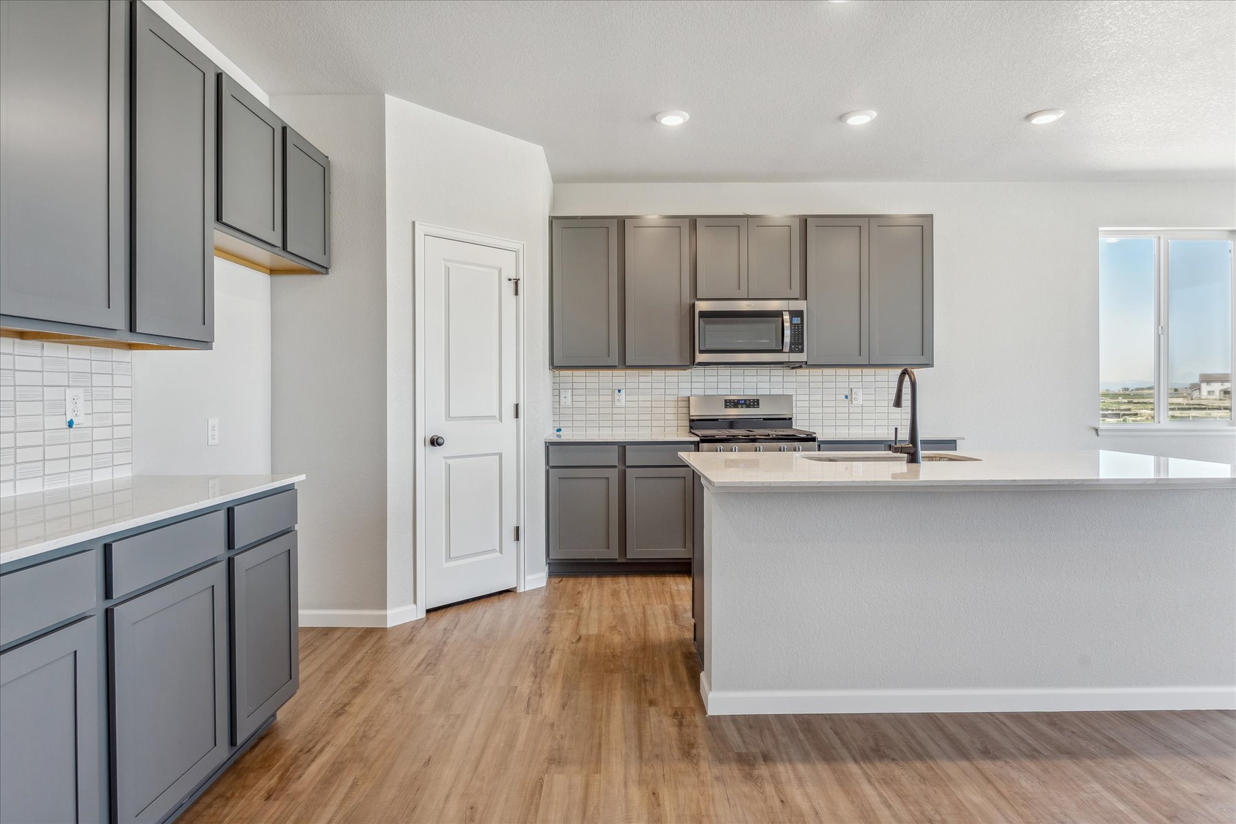 A kitchen with black cabinets.