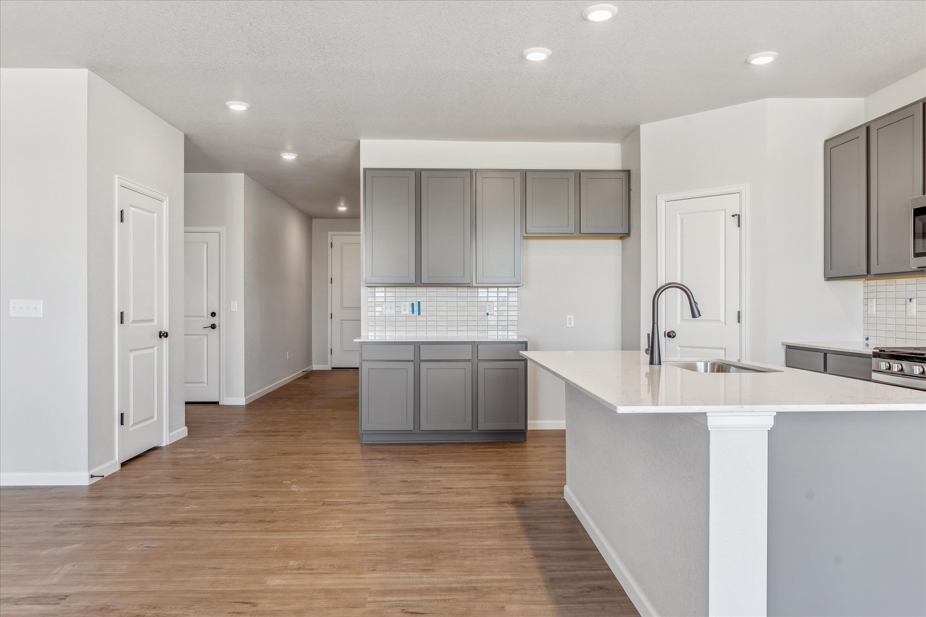 A kitchen with white cabinets.