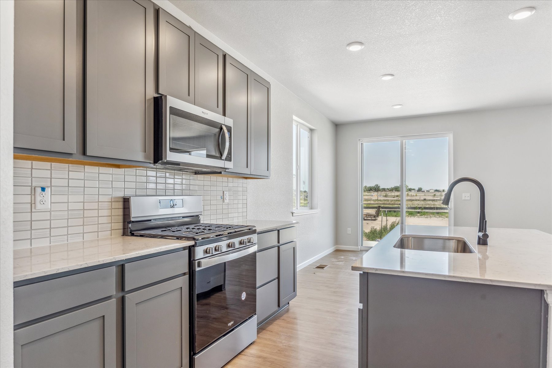 A kitchen with white cabinets.