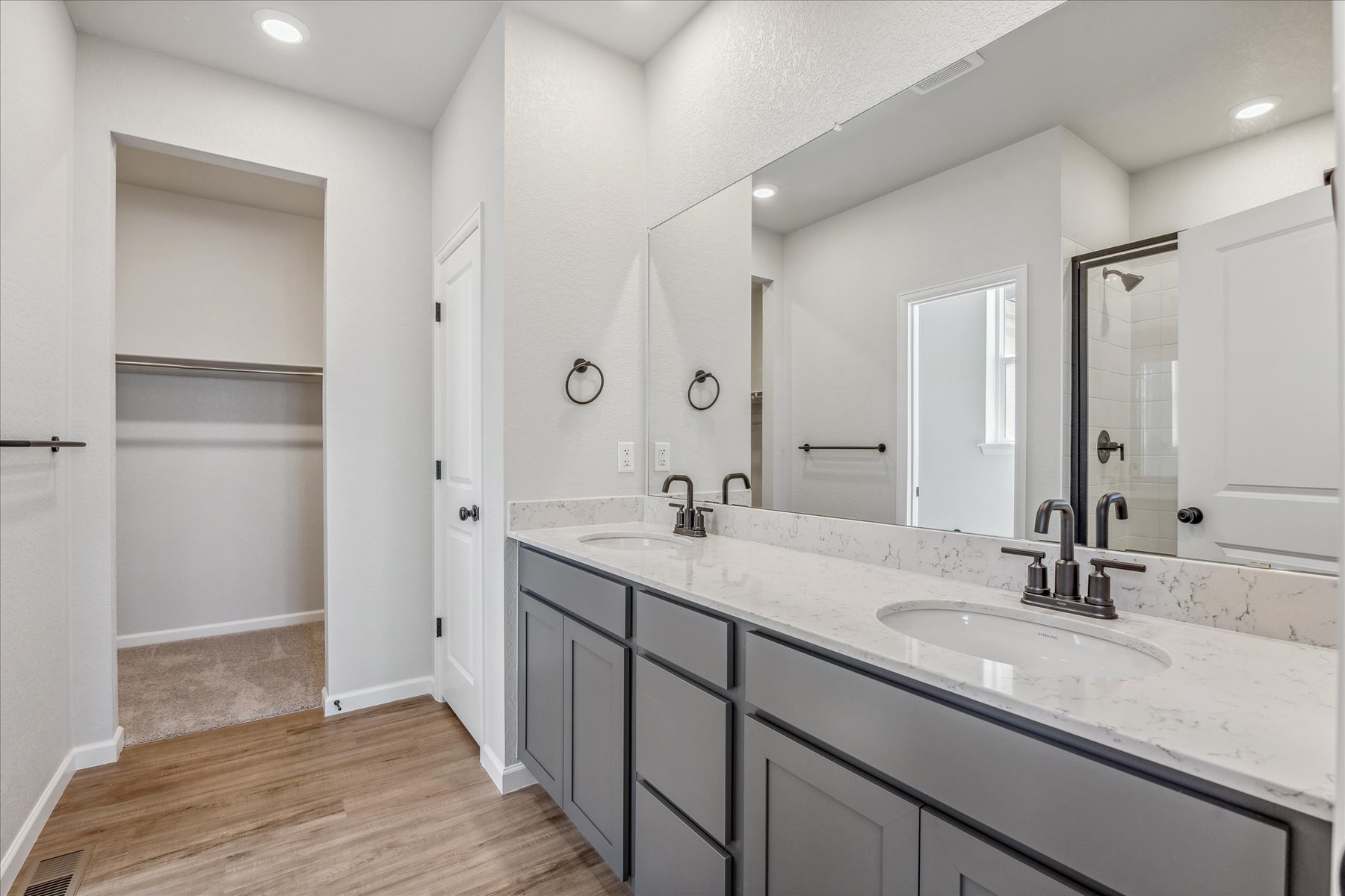 A bathroom with a large mirror.