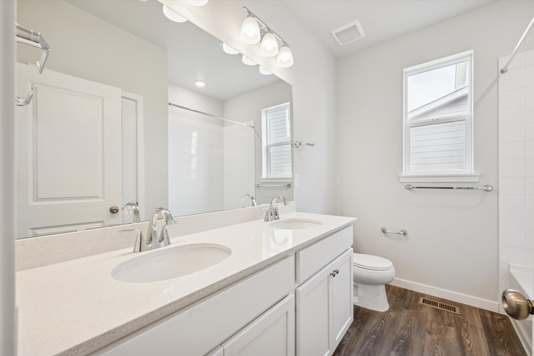 A bathroom with a large mirror.