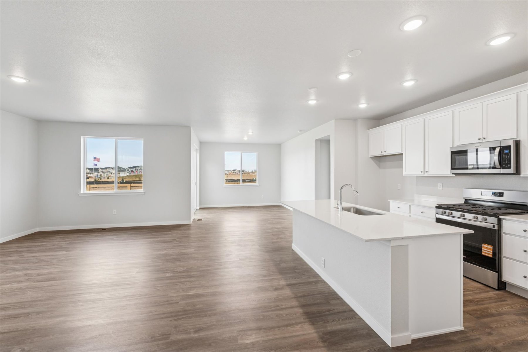 A kitchen with white cabinets.