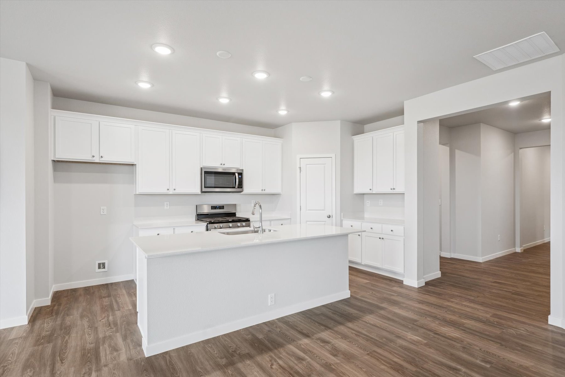 A kitchen with white cabinets.