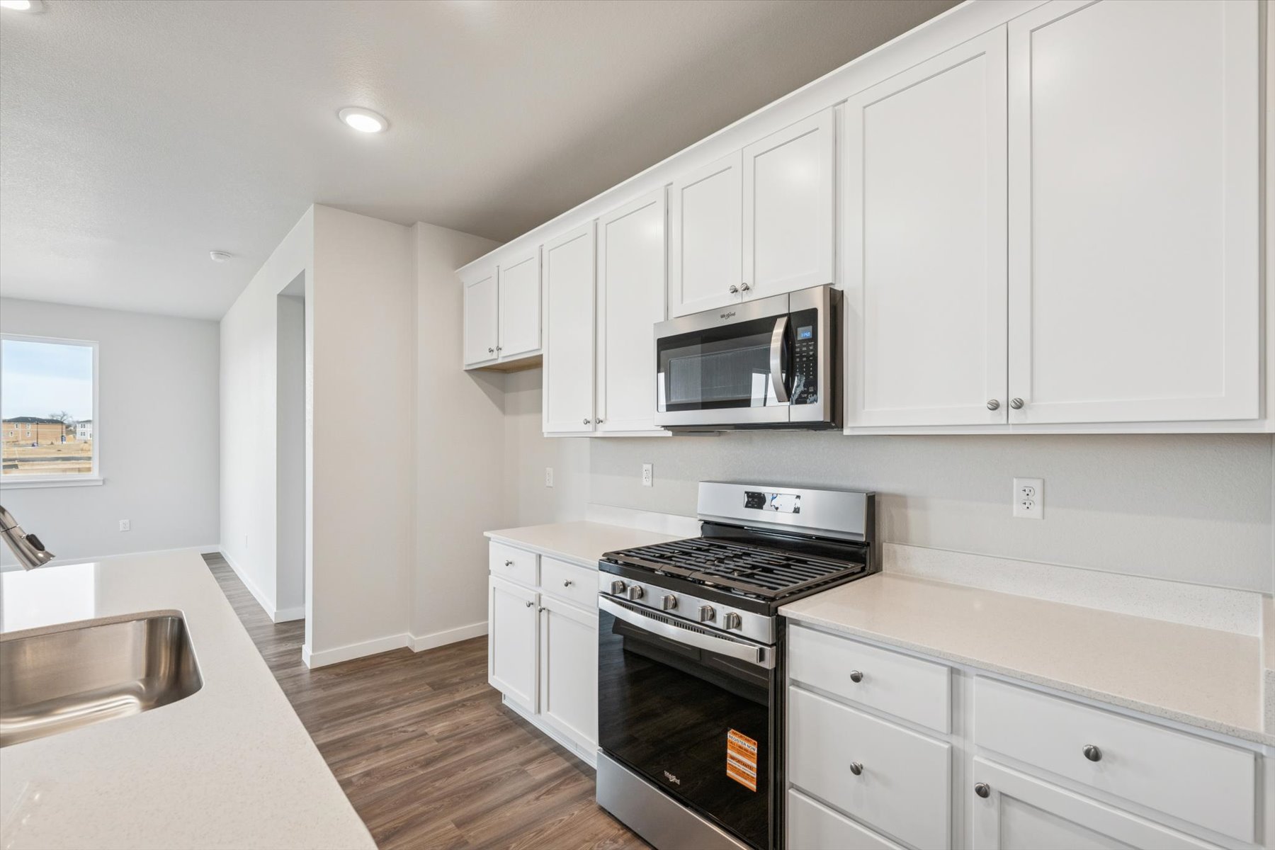 A kitchen with white cabinets.