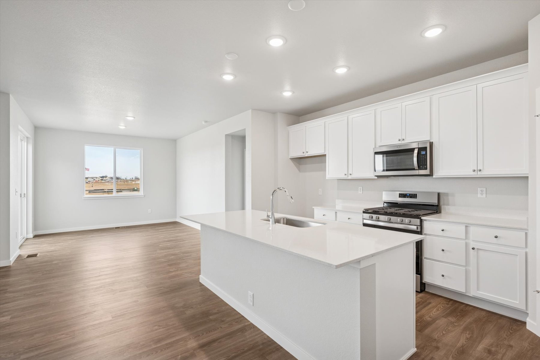 A kitchen with white cabinets.