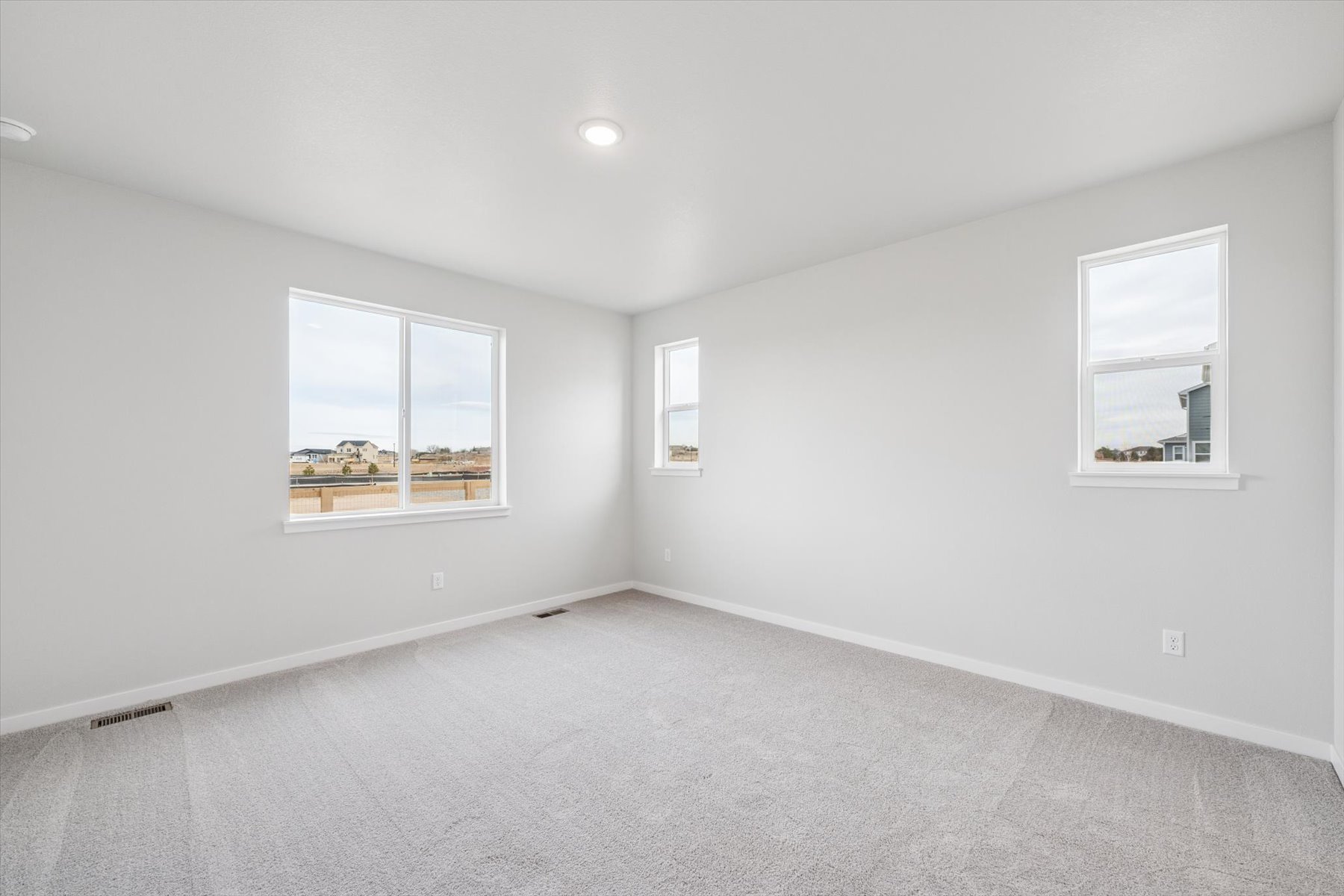 A room with white walls and windows.