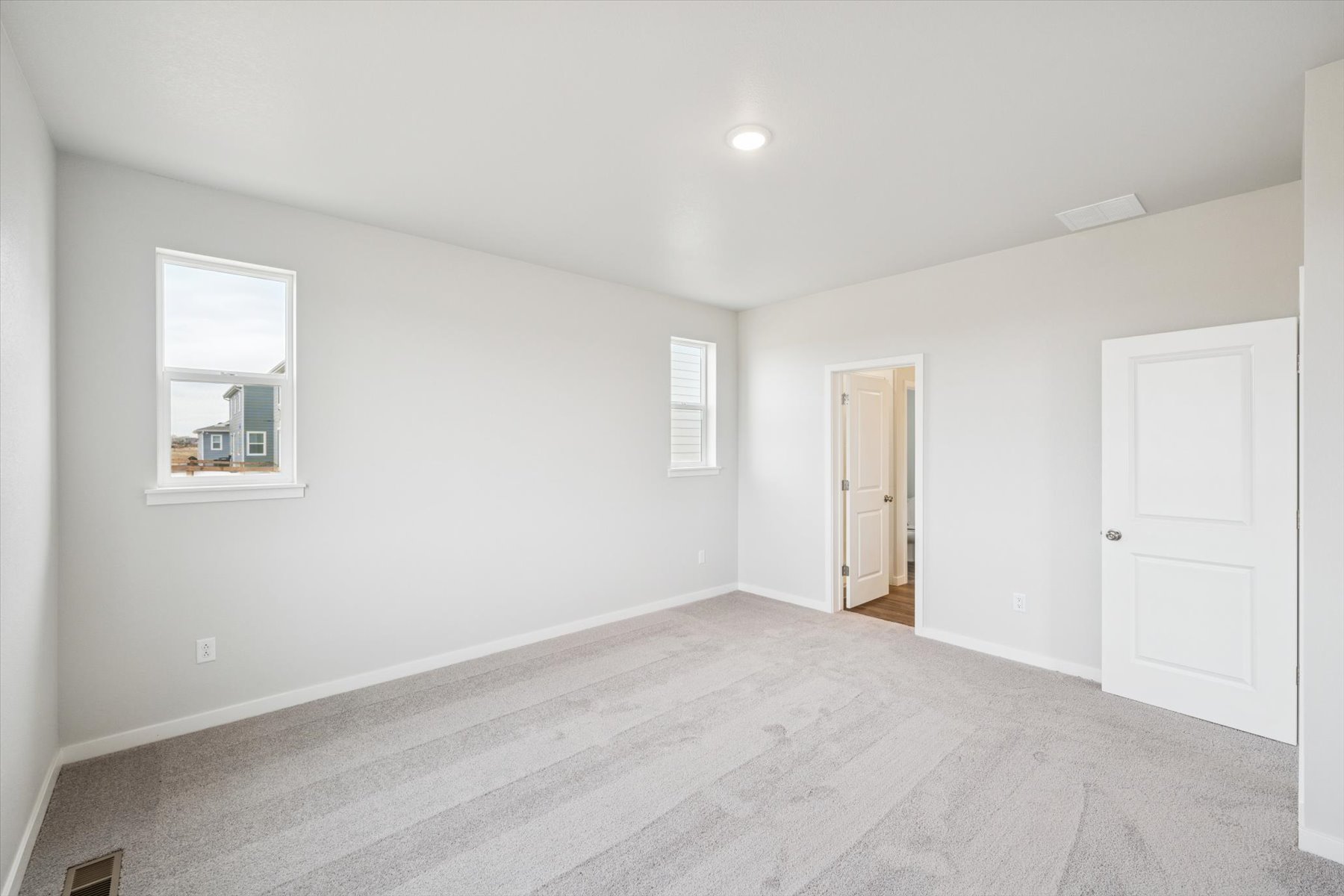 A room with white walls and a white door.