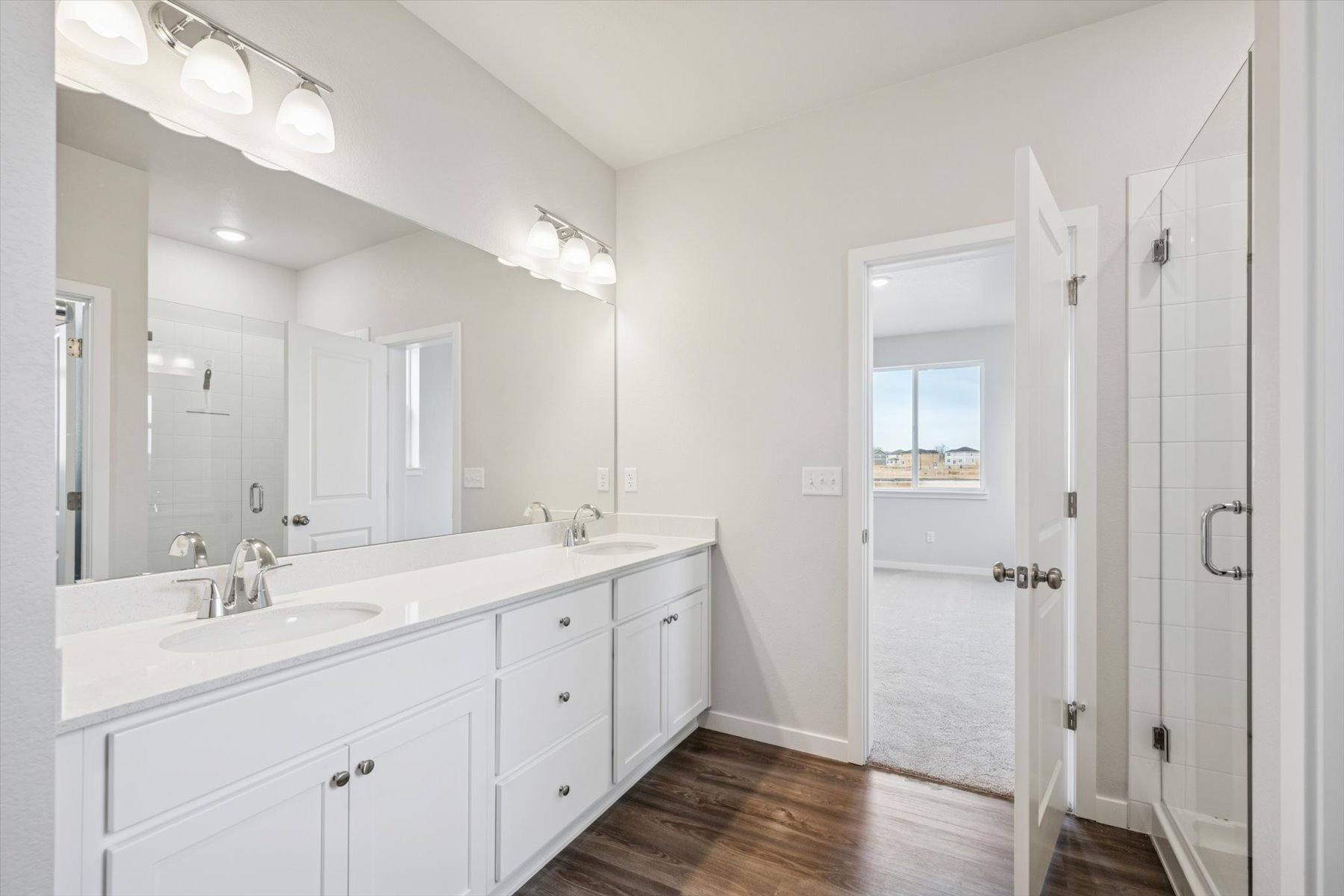 A bathroom with white cabinets.