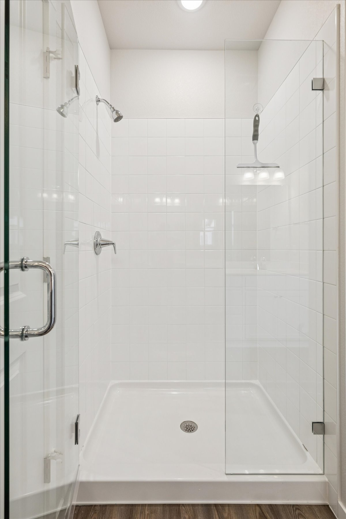 A bathroom with a bathtub and shower unit.
