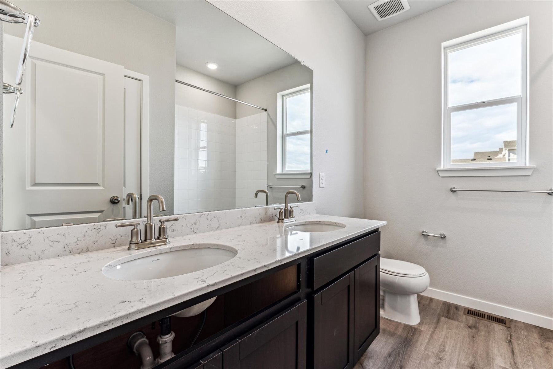 A bathroom with a large mirror.