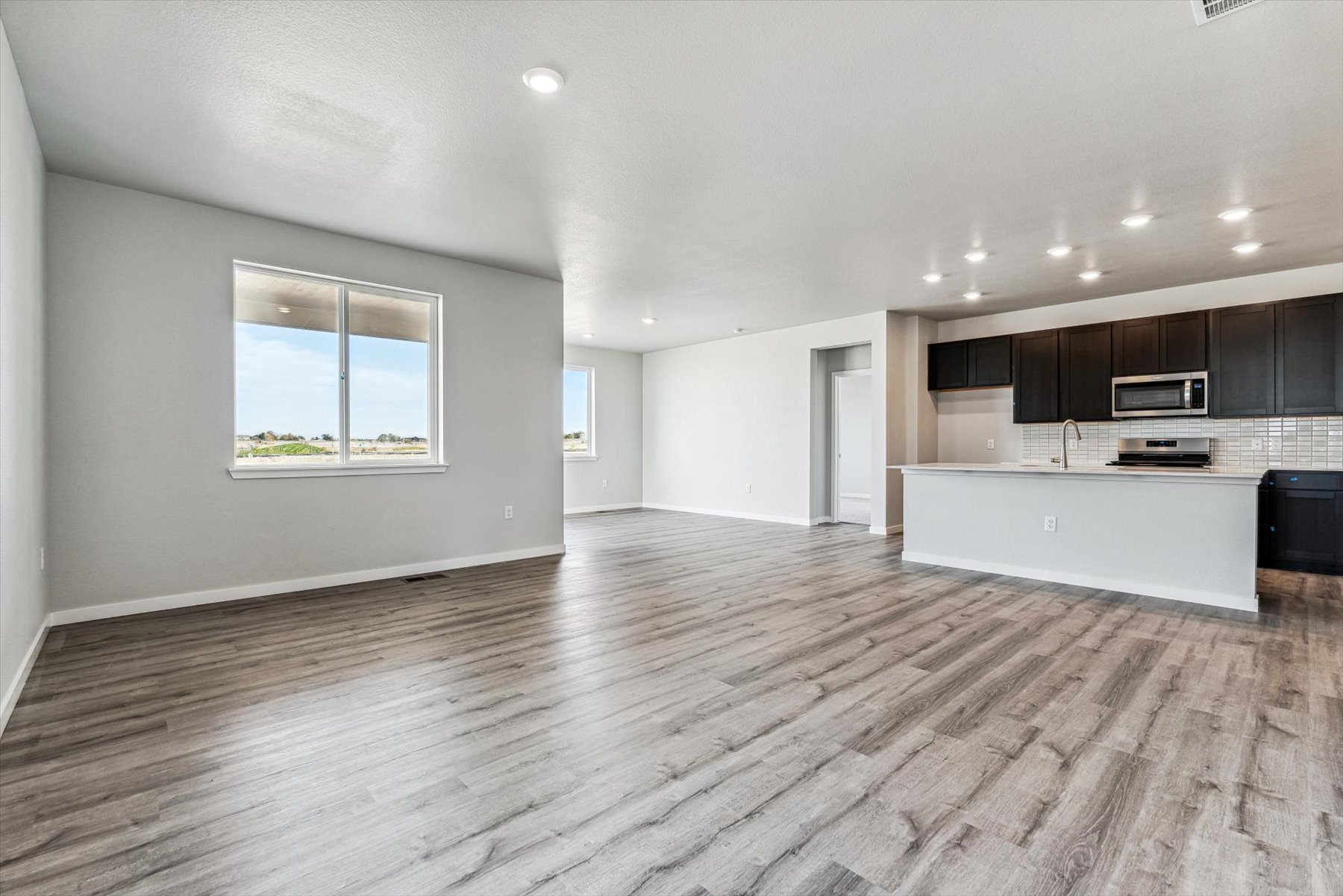 A large empty room with a wood floor.