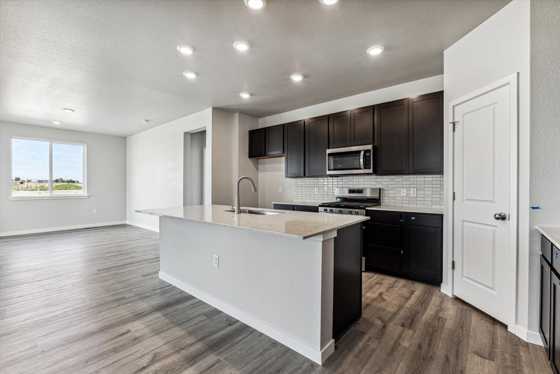 A kitchen with black cabinets.