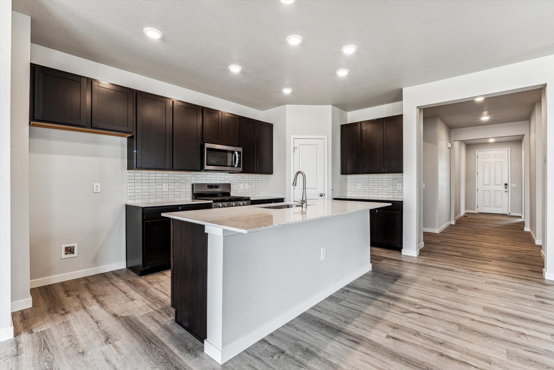 A kitchen with black cabinets.