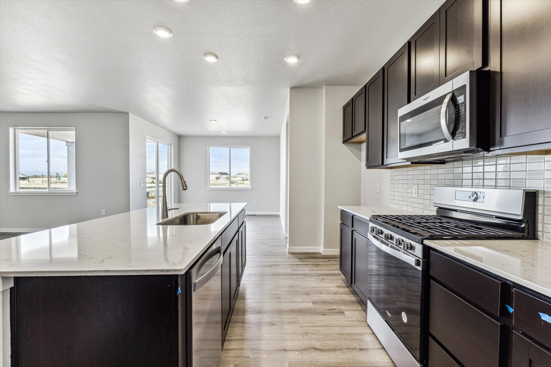 A kitchen with black cabinets.