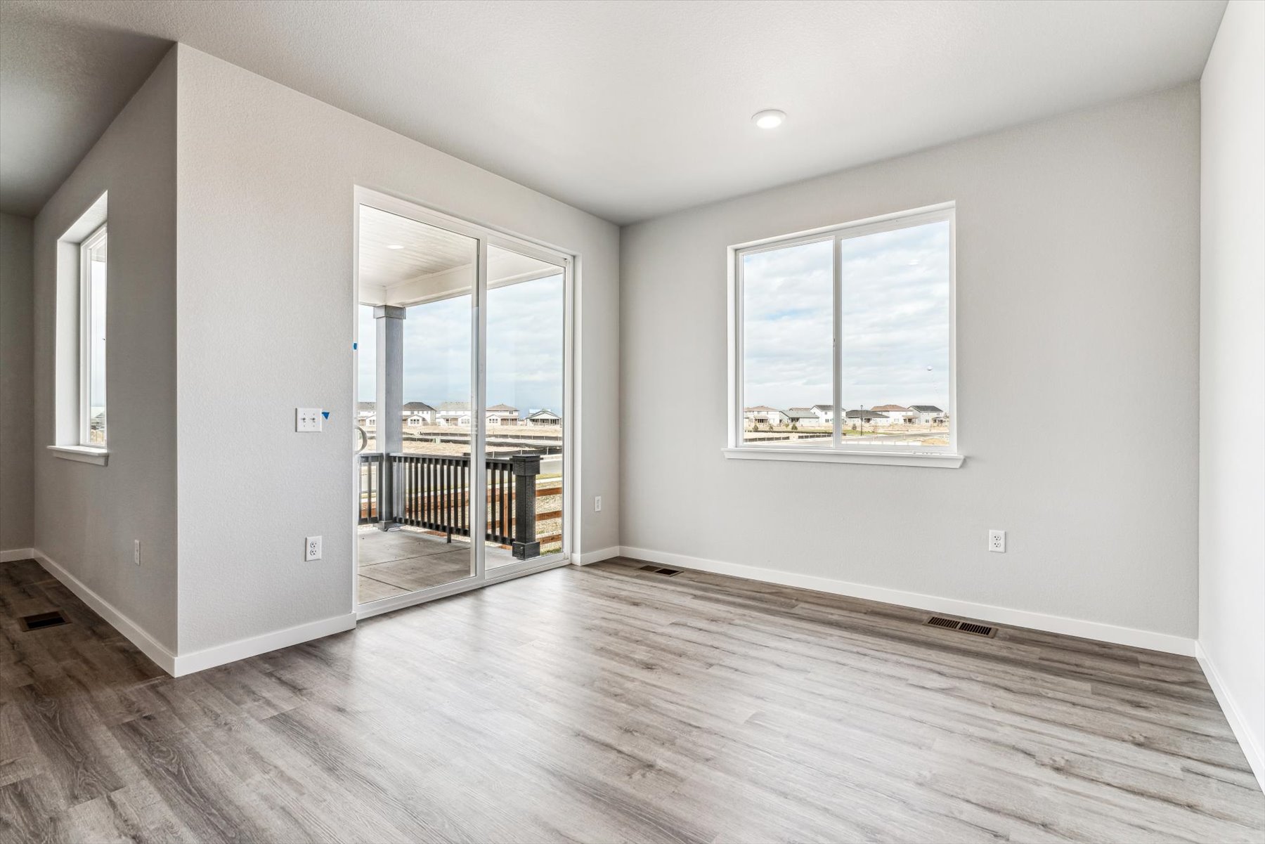 A room with a wood floor and a wood floor with a window.