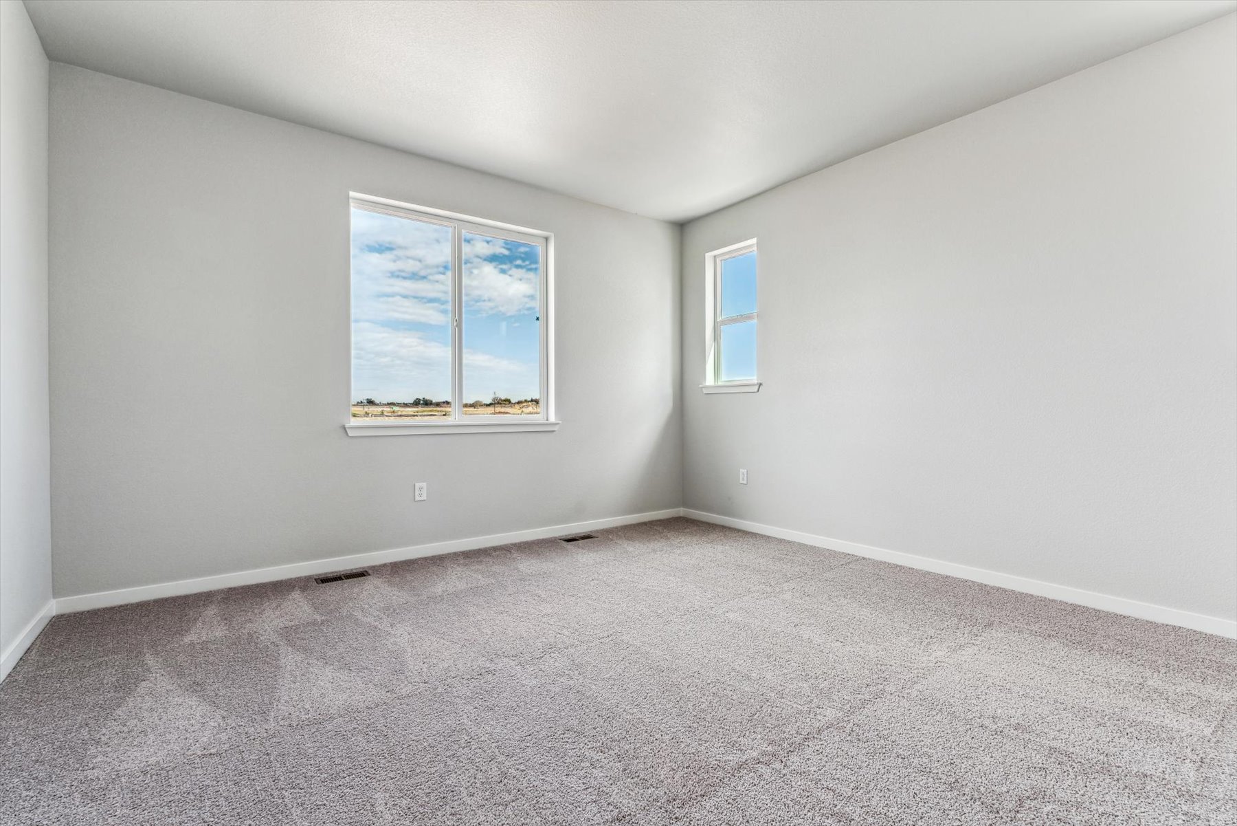 A room with a window and a carpet.