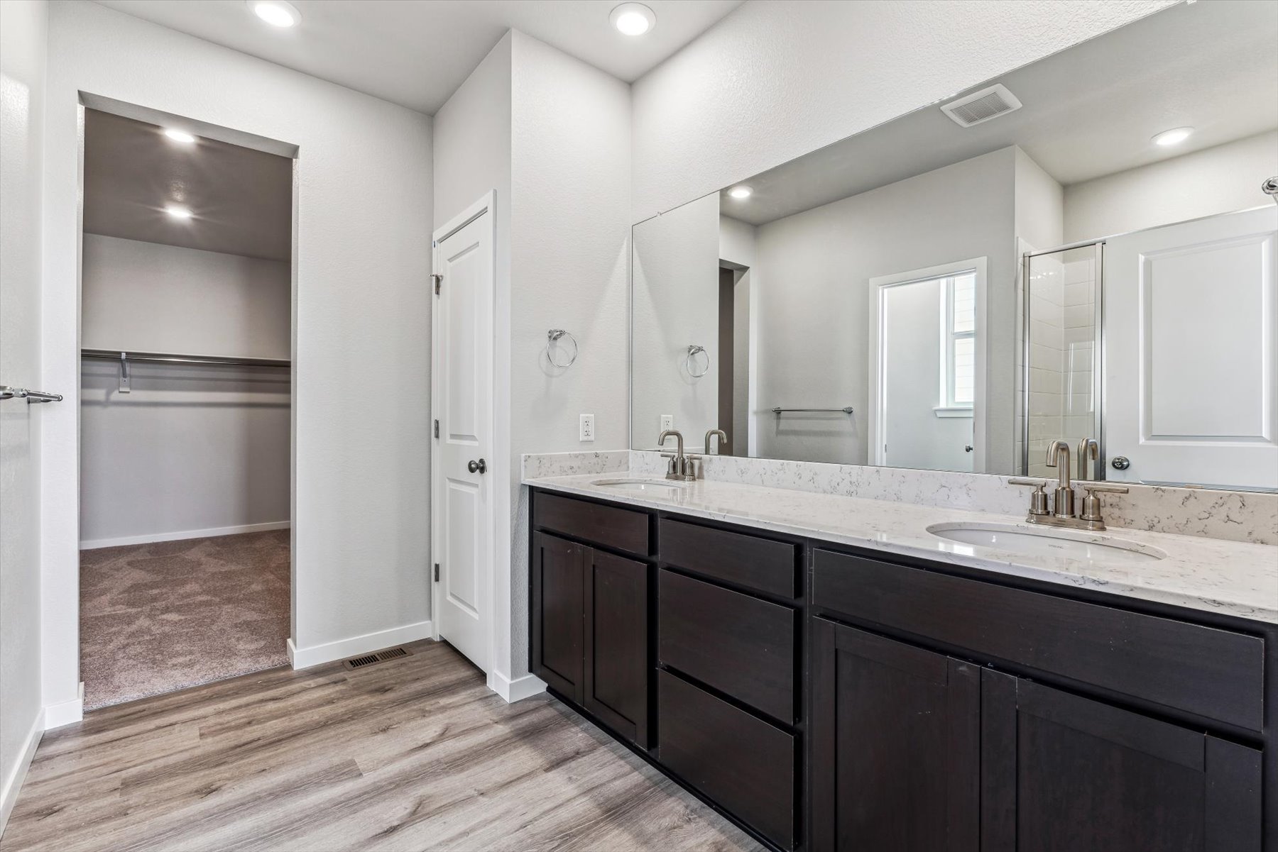 A bathroom with a large mirror.