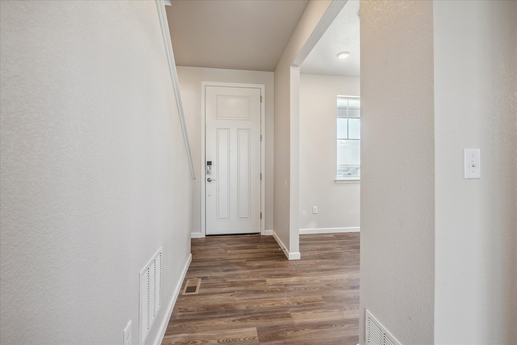 A hallway with white walls.