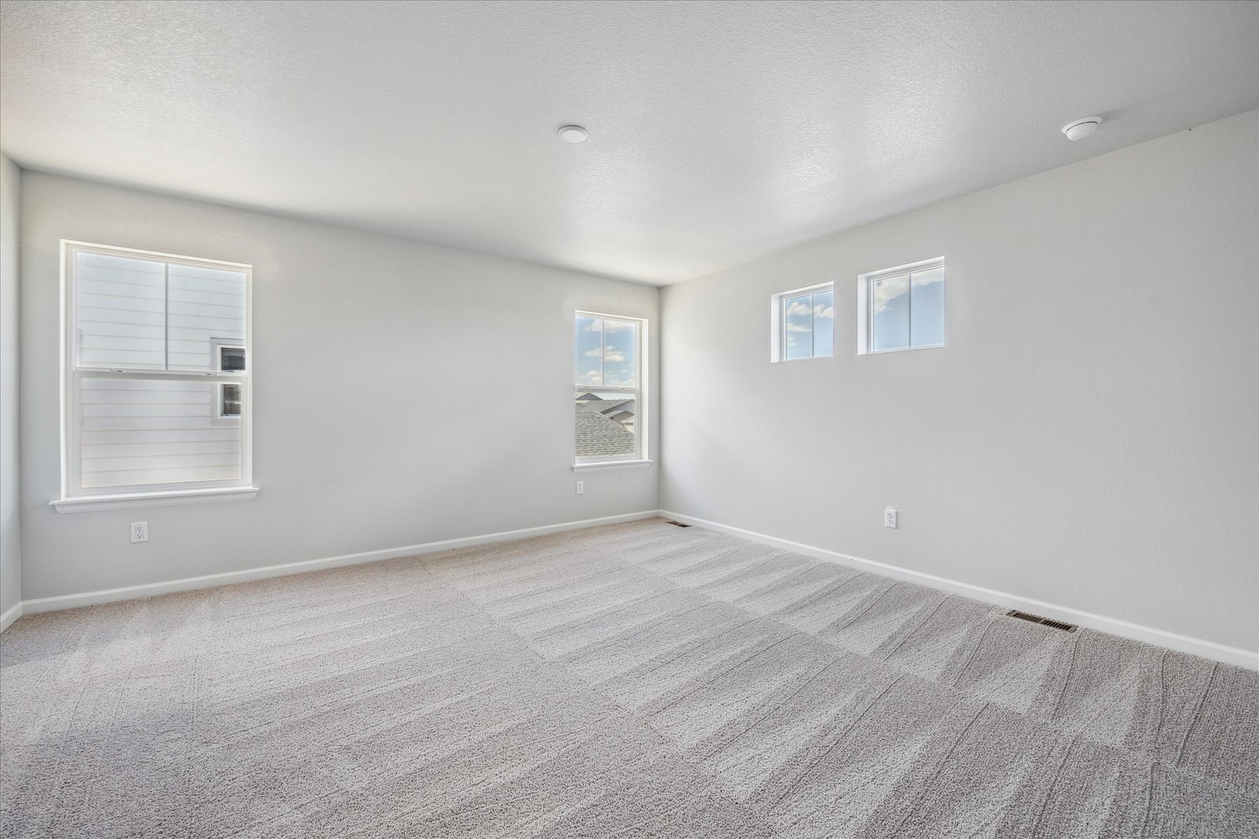 A room with a carpet and a rug.