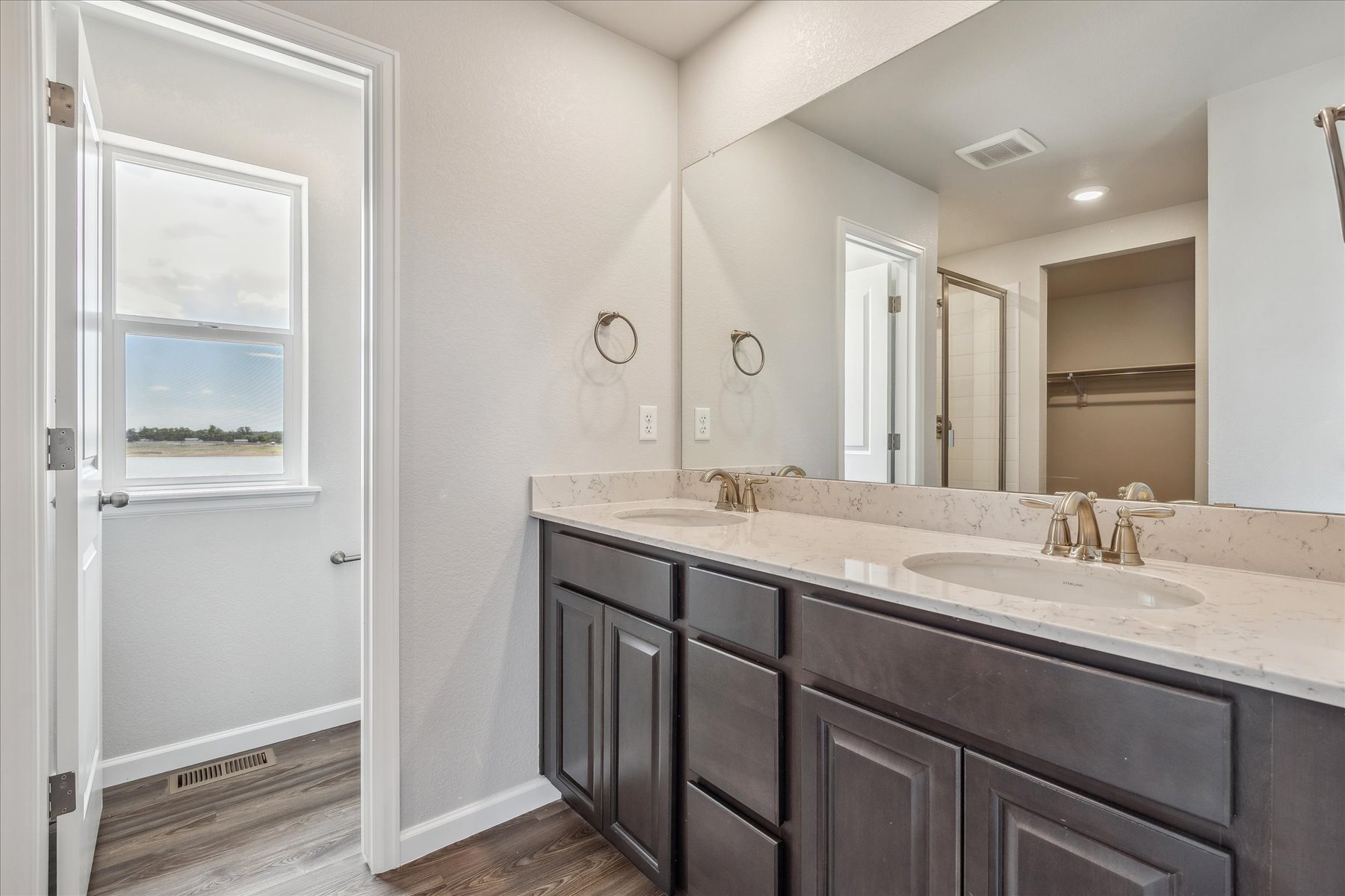 A bathroom with a large mirror.