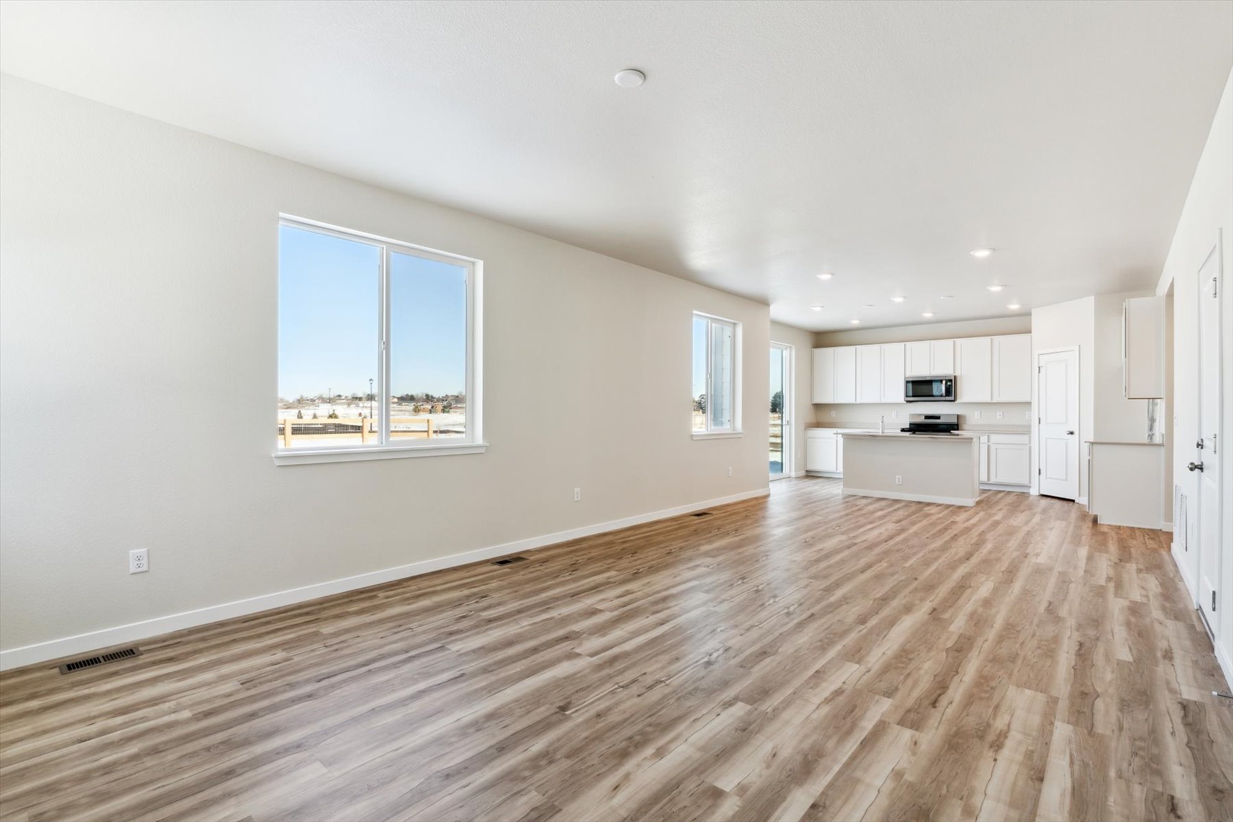 A large empty room with a wood floor.