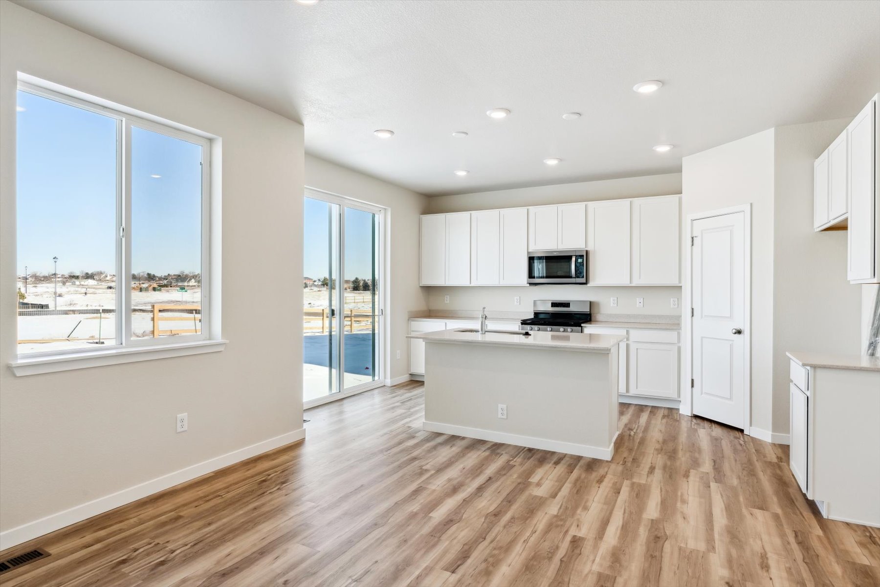 A kitchen with white cabinets.