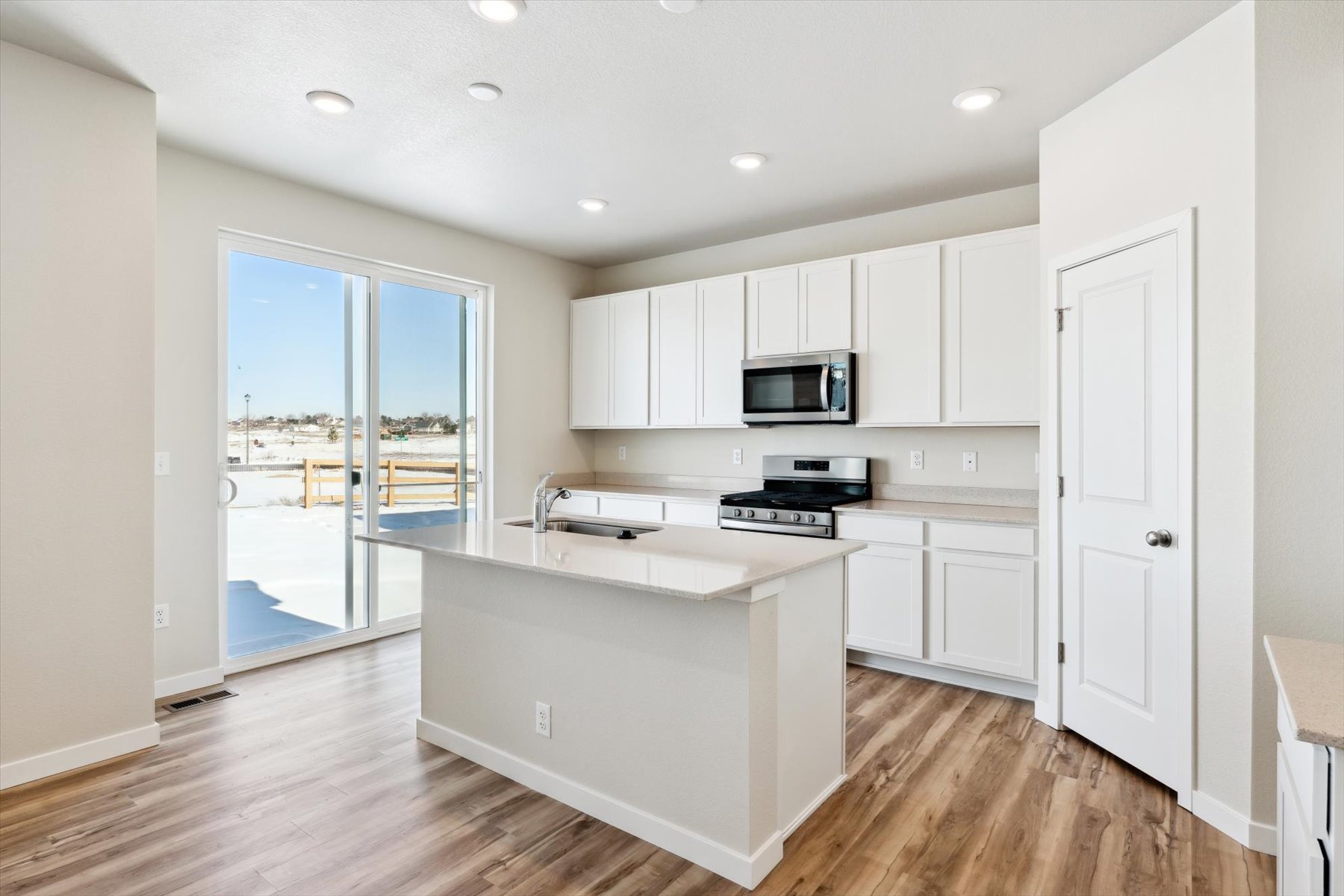 A kitchen with white cabinets.