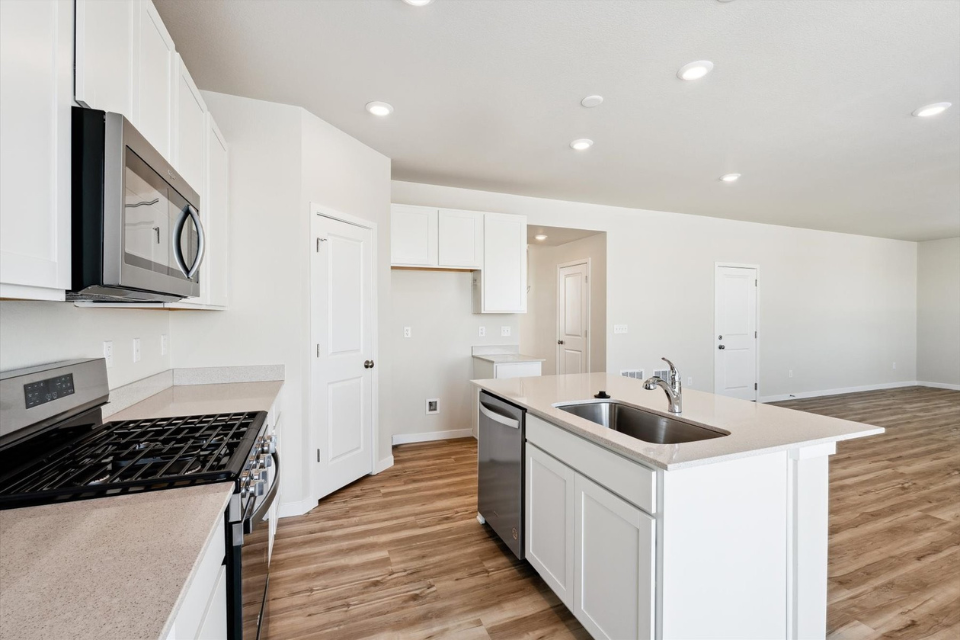 A kitchen with white cabinets.