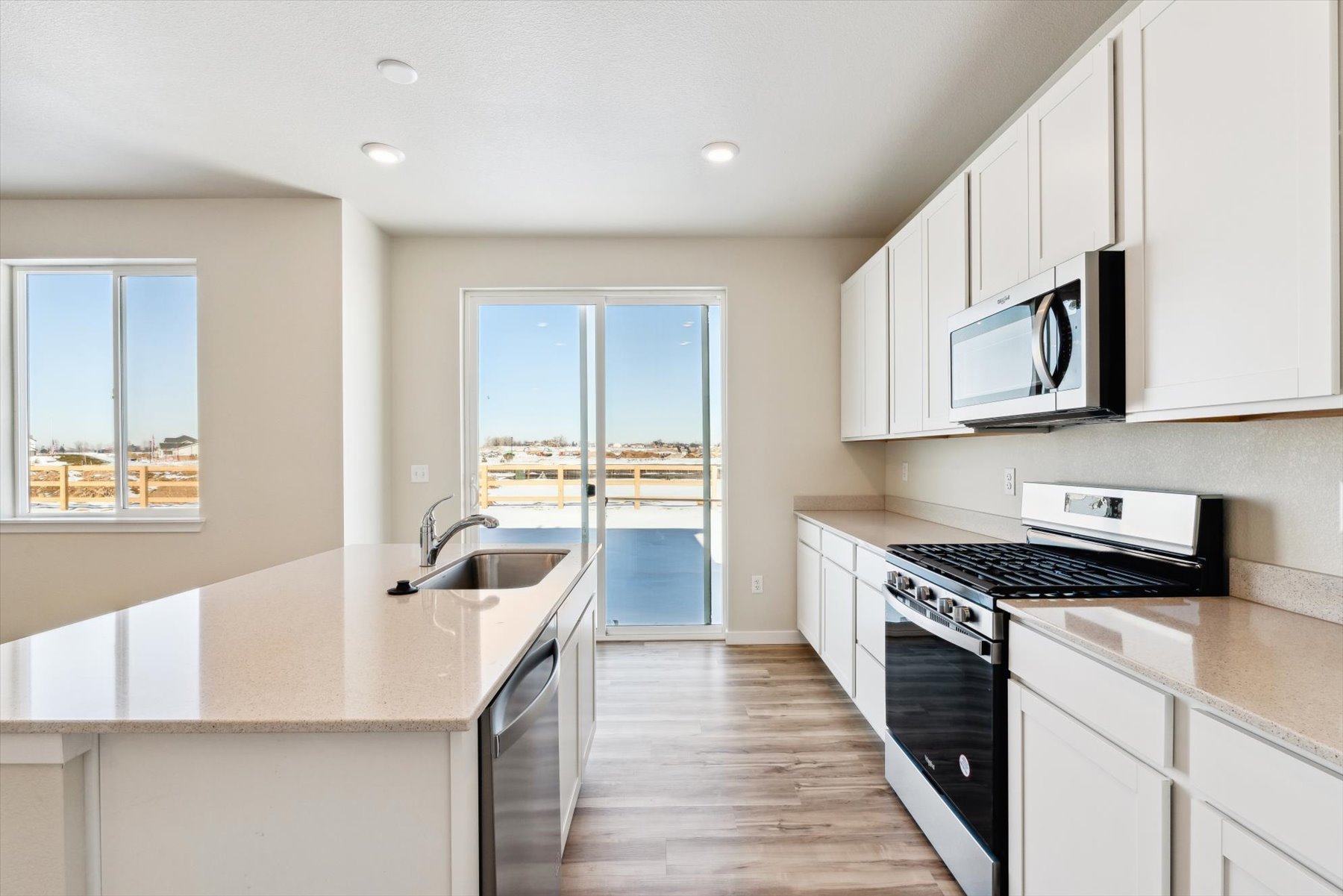 A kitchen with white cabinets.