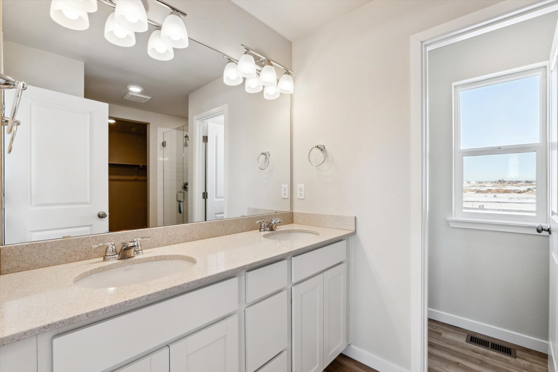 A bathroom with a large mirror.