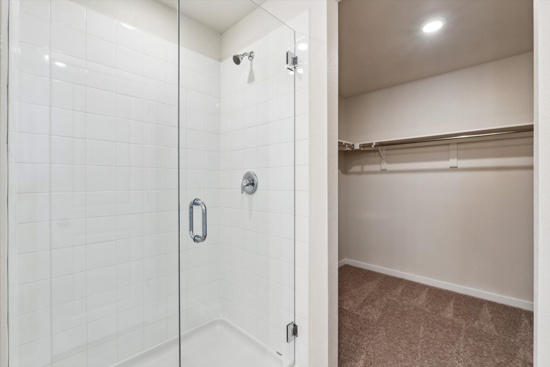 A shower with a glass door.