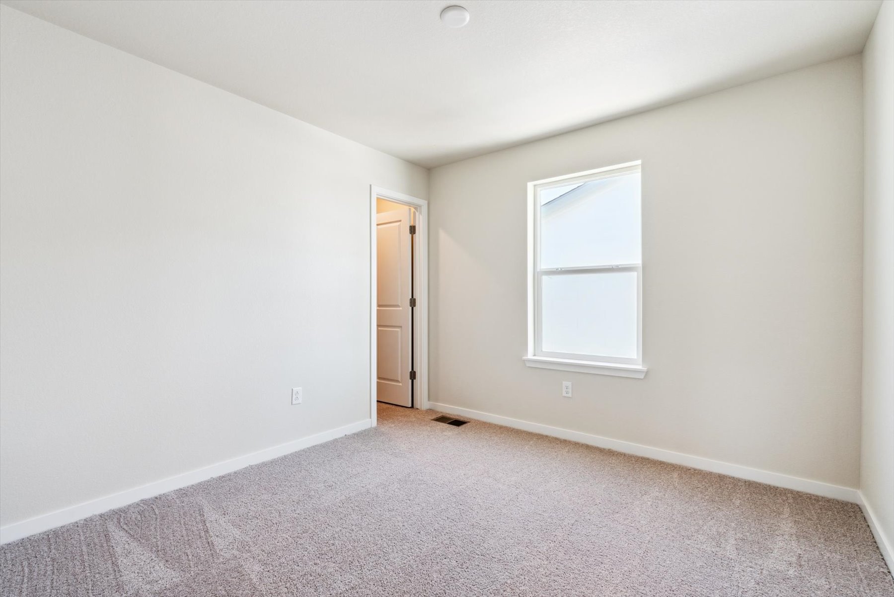 A room with a door and a window.