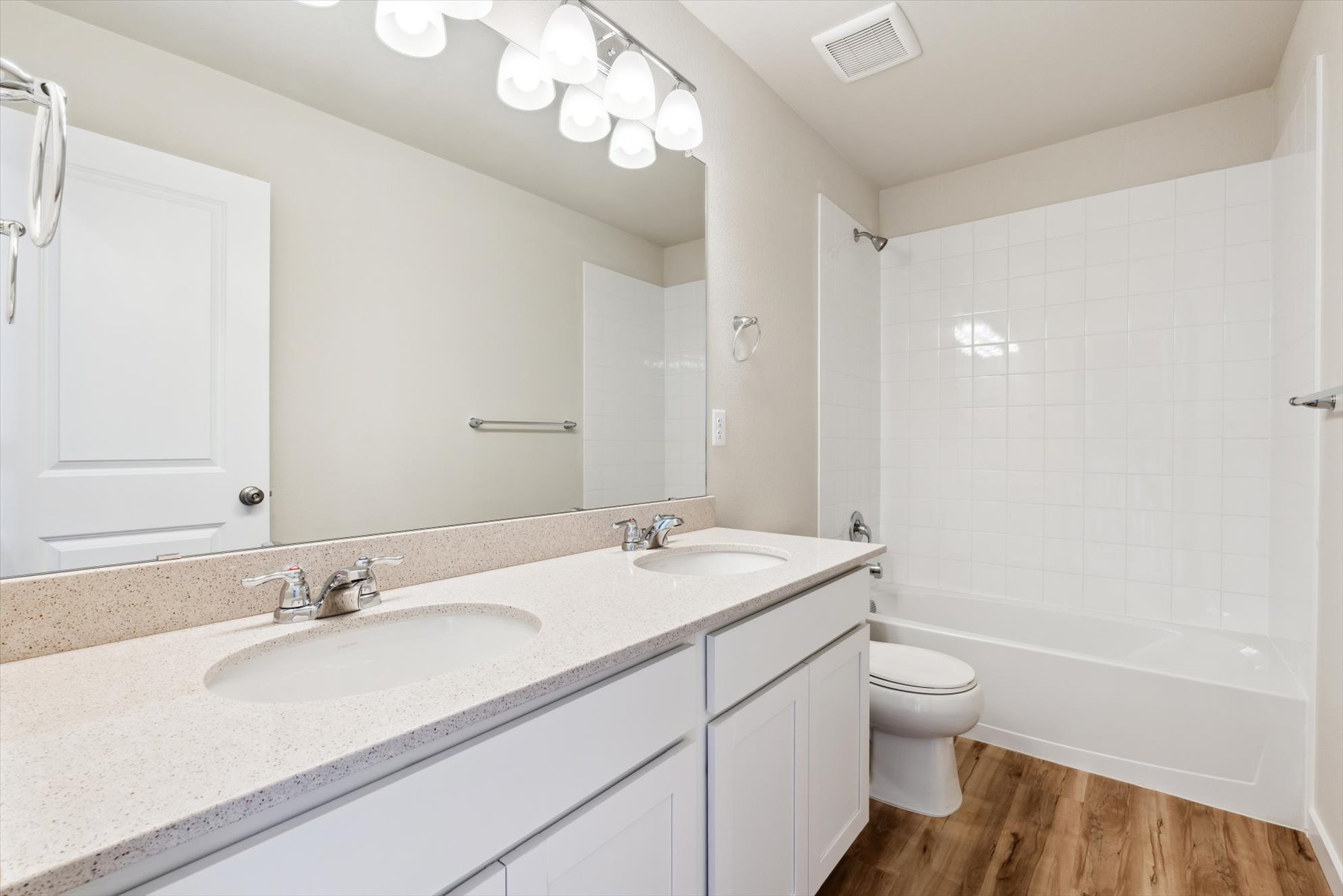 A bathroom with a tub sink and toilet.
