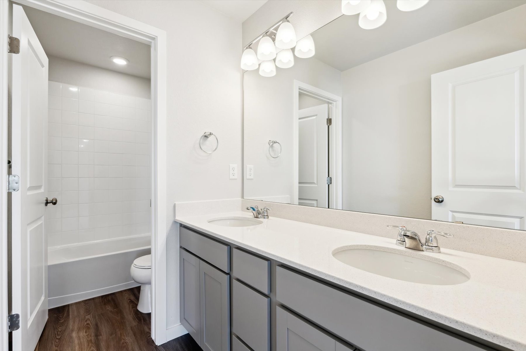 A bathroom with a large mirror.