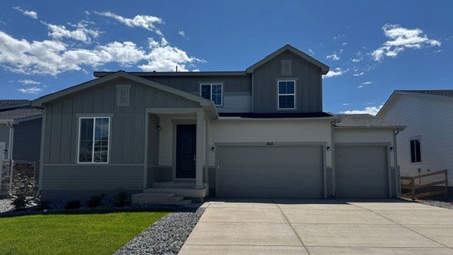 A house with garages and grass.
