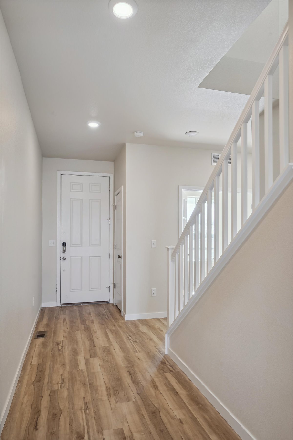 A hallway with white walls.