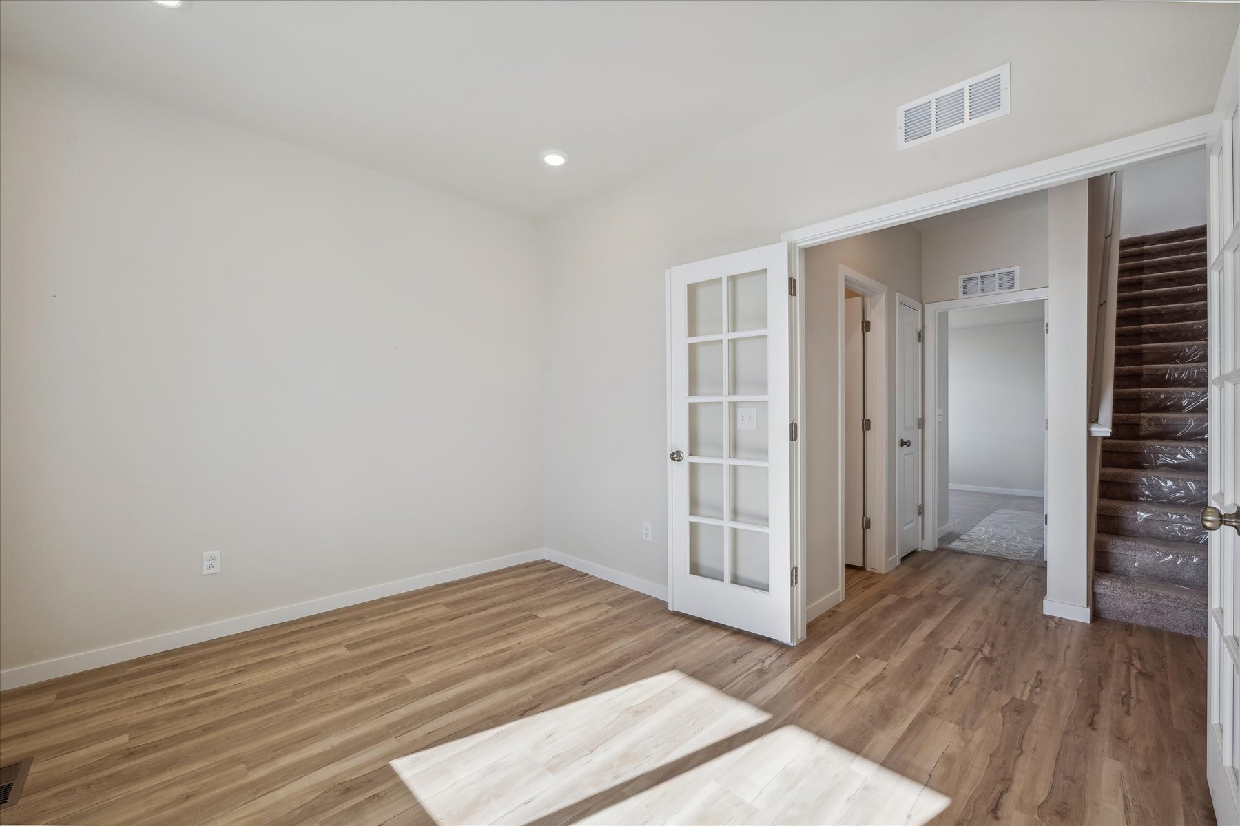 A room with a wood floor and a wood floor.