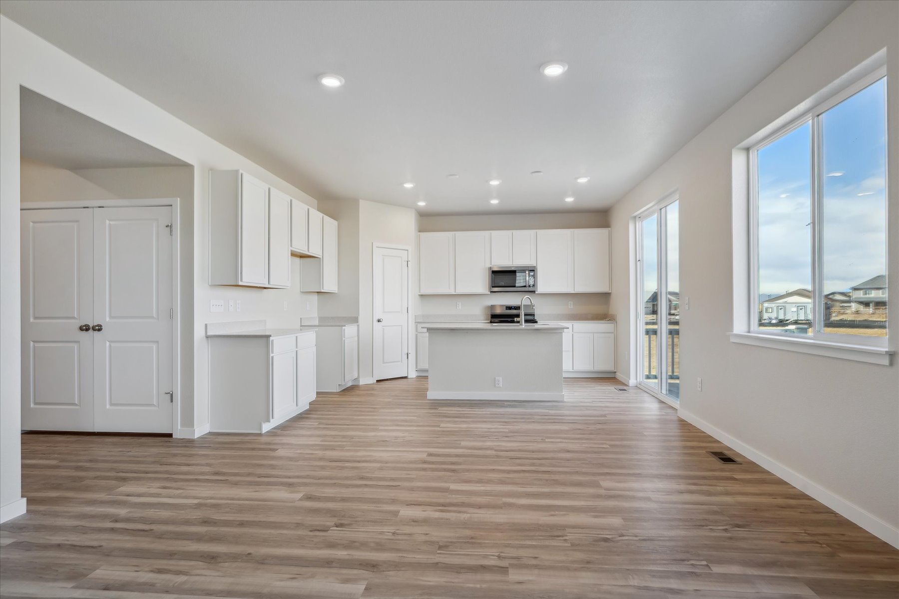 A large kitchen with white cabinets.