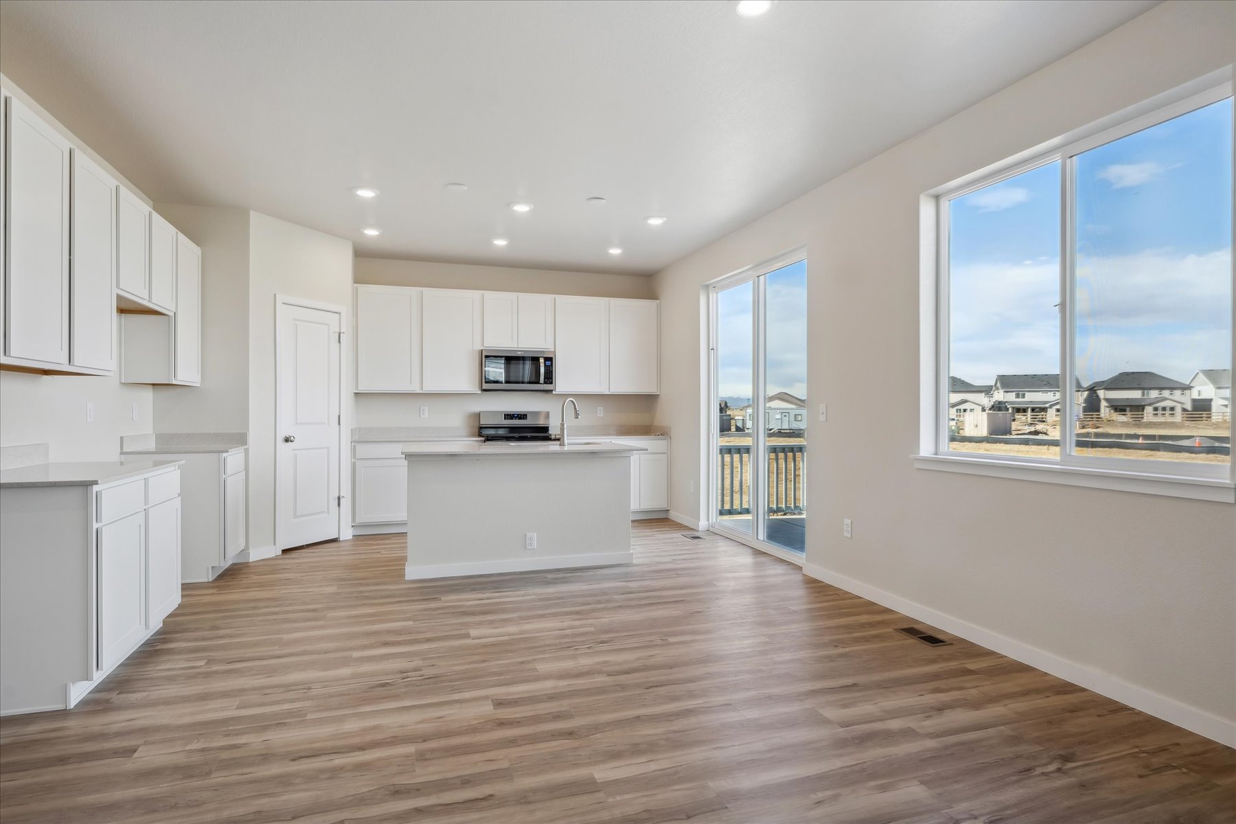 A large kitchen with white cabinets.