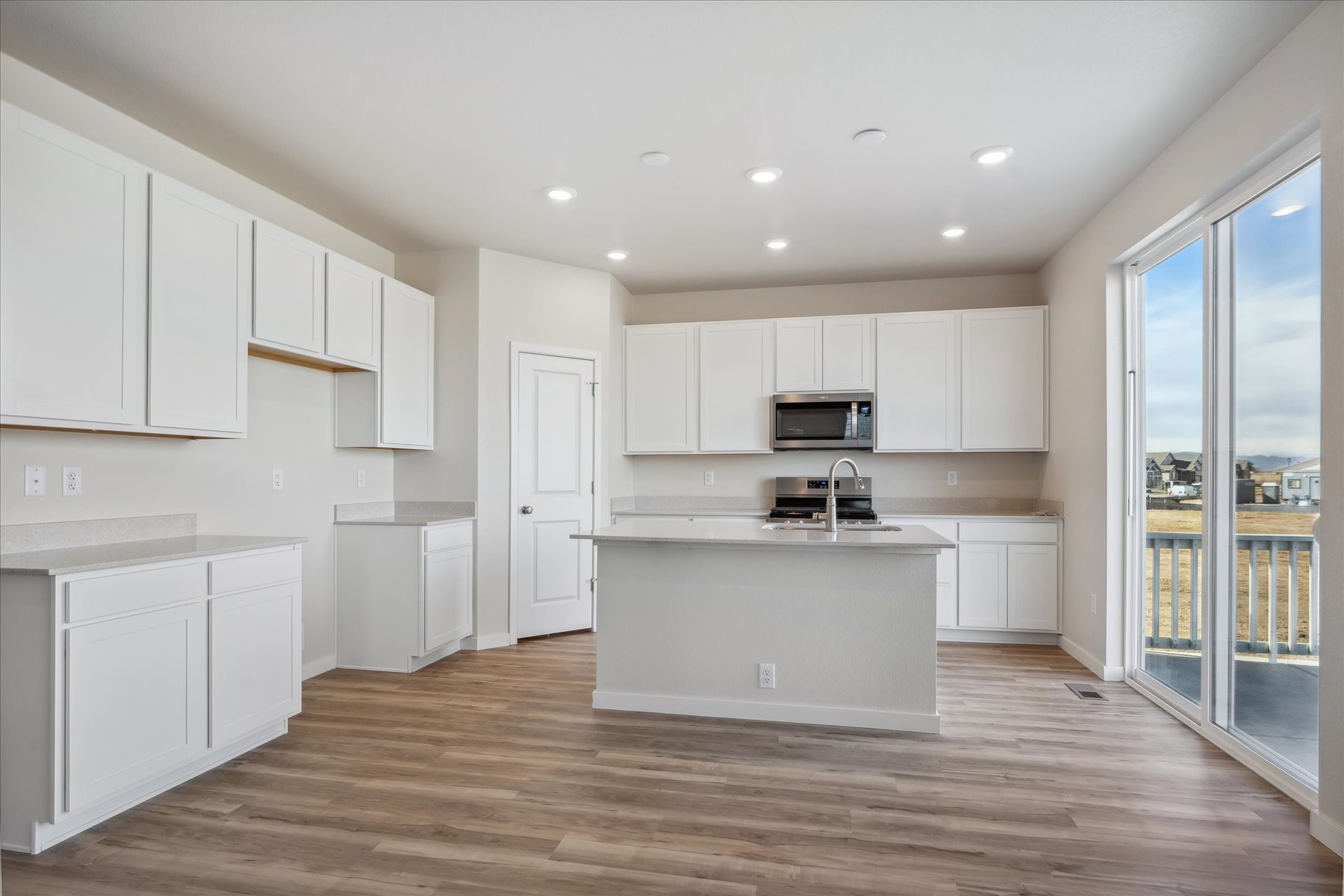 A kitchen with white cabinets.