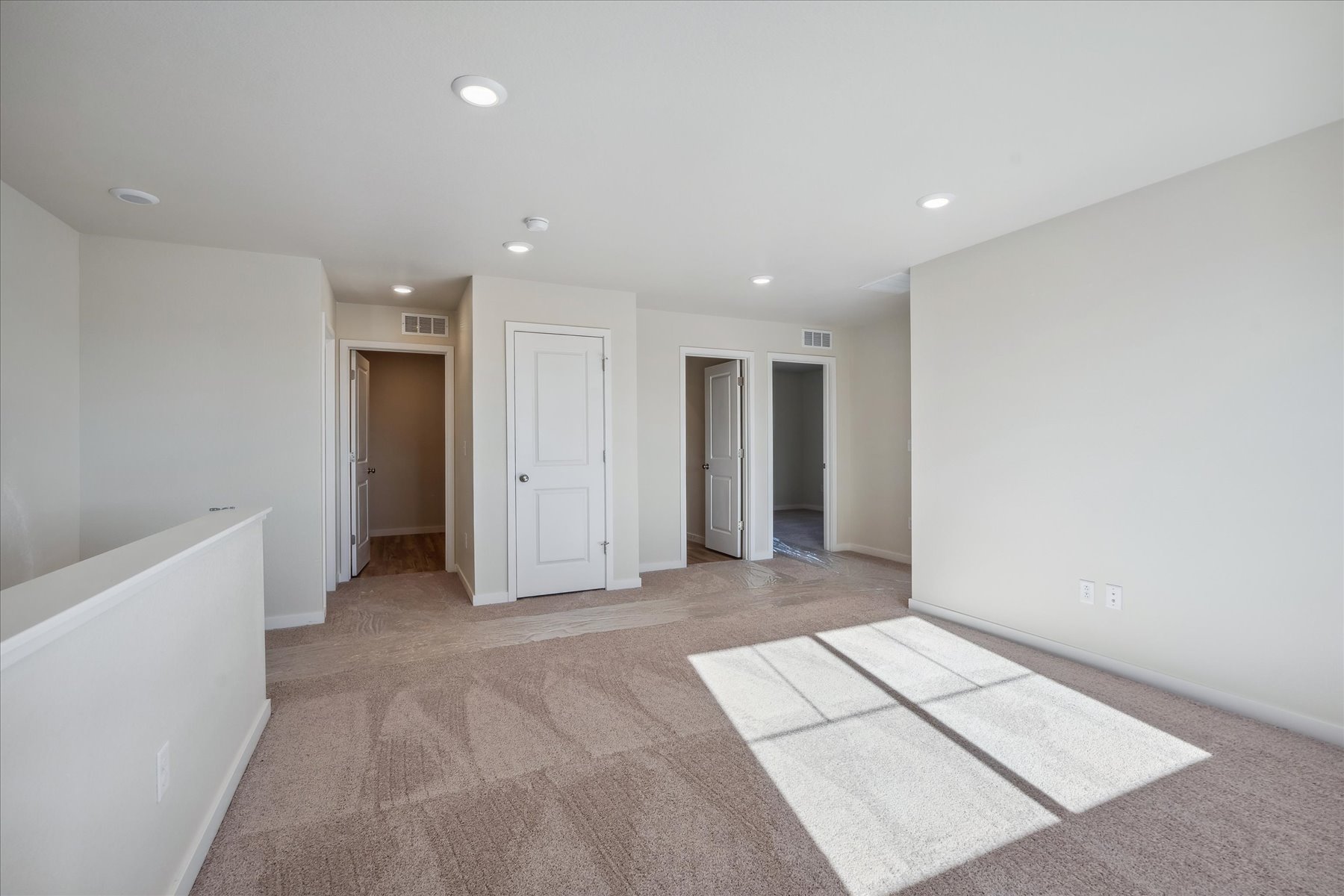 A room with white walls and a rug.